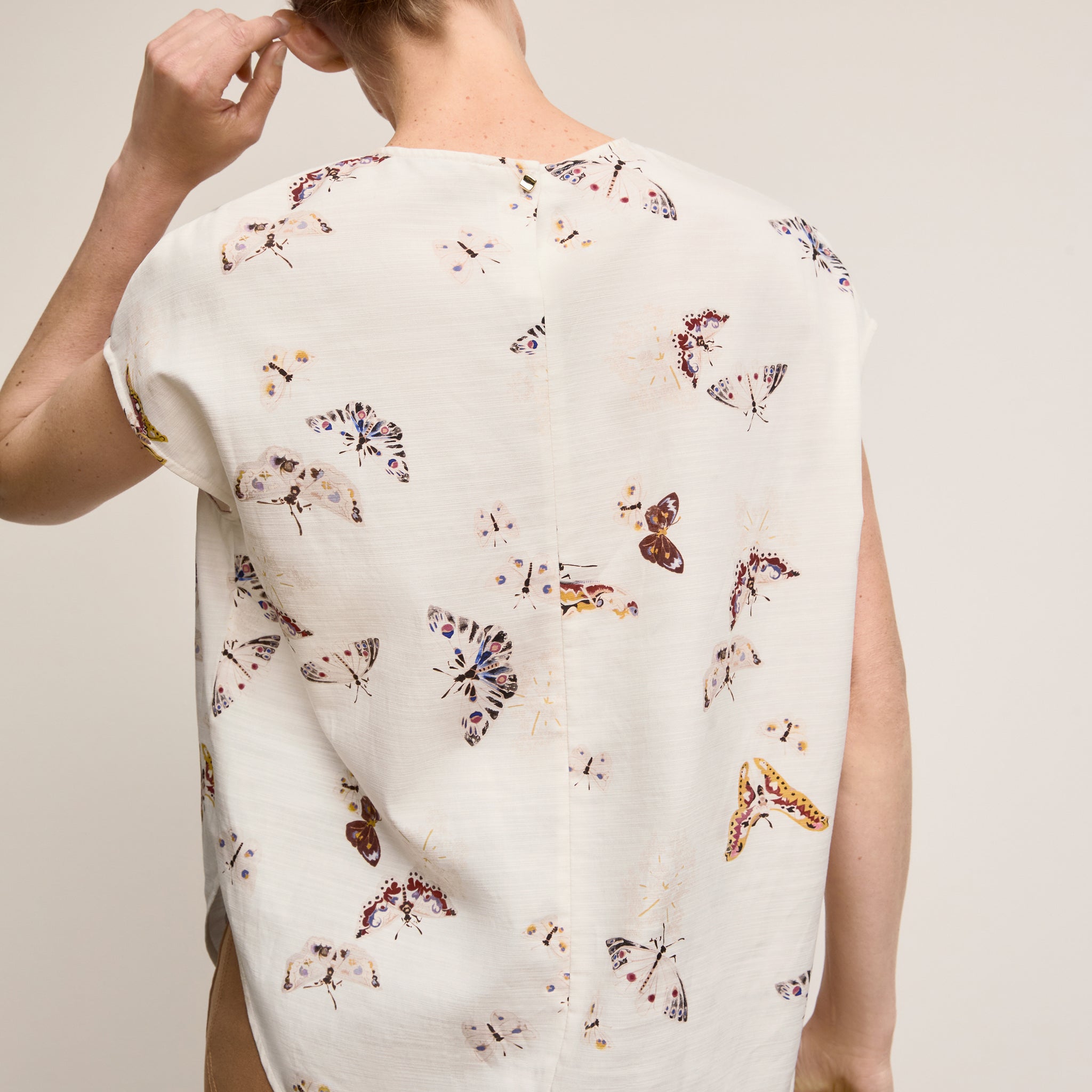 Back image of a woman wearing The Didion Top - Airy Cotton :: Butterfly Print 