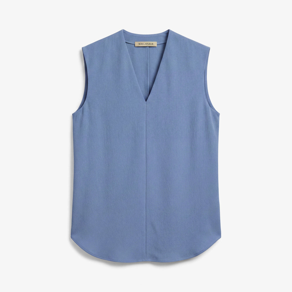 A sleeveless light blue V-neck top with a curved hem, displayed flat against a clean off-white background.