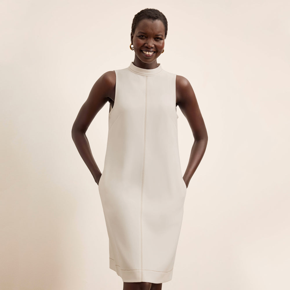 front image of a woman wearing the farren dress in eggshell