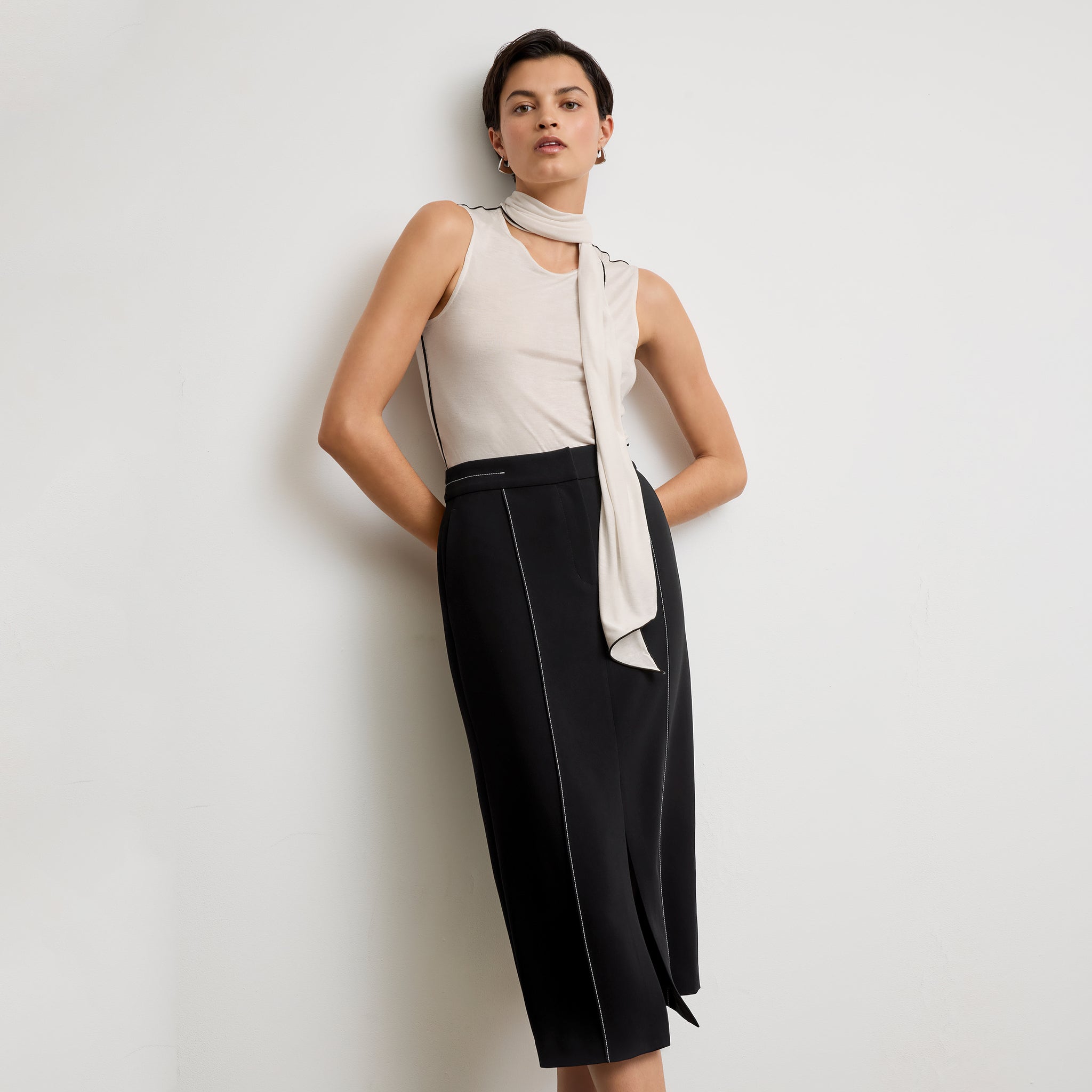 front image of a woman wearing the meghan skirt in black with topstitch