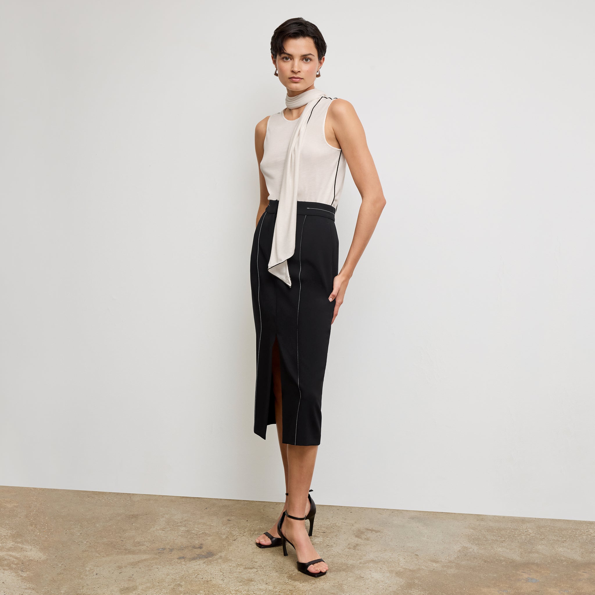 front image of a woman wearing the meghan skirt in black with topstitch