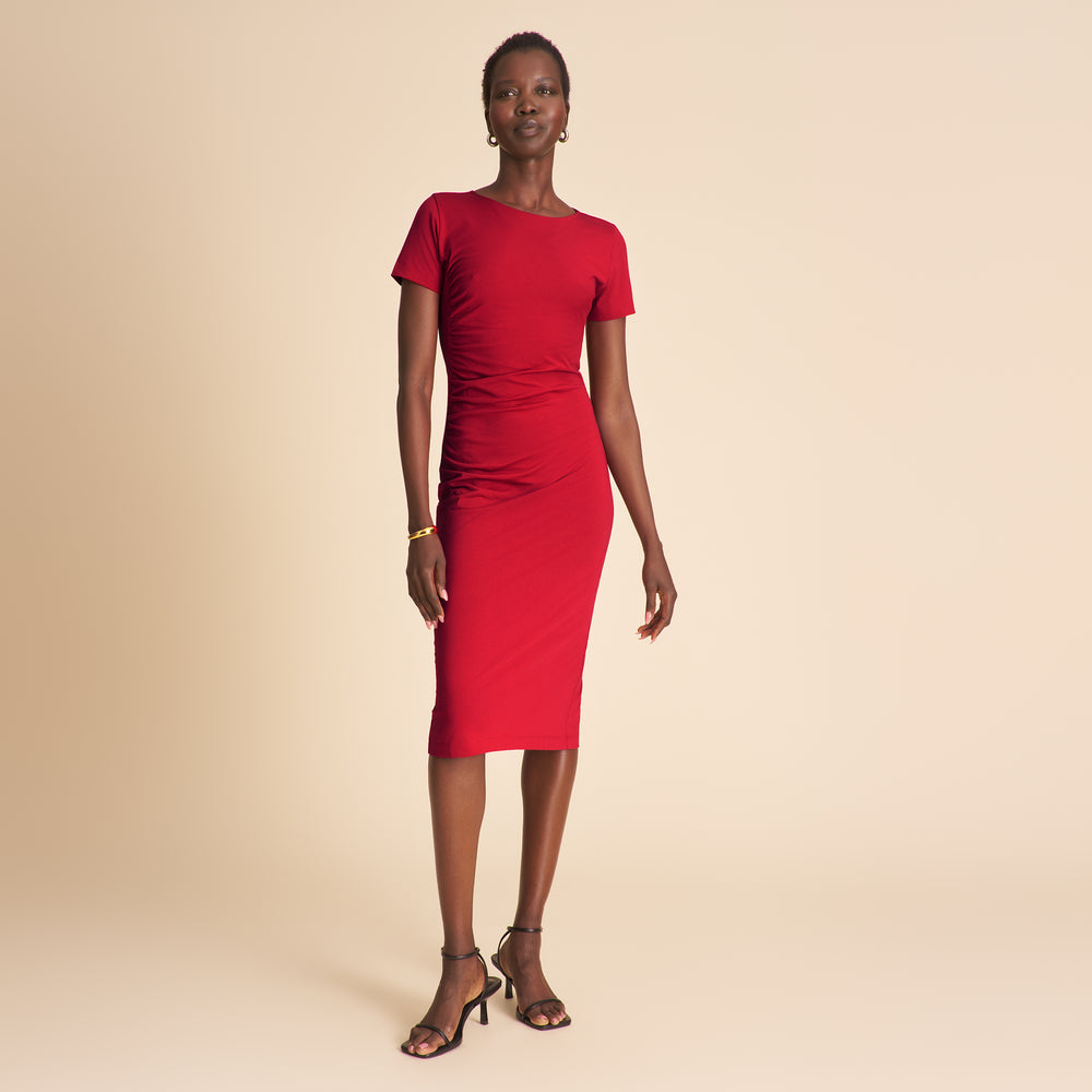 Woman wearing a red dress on a beige background