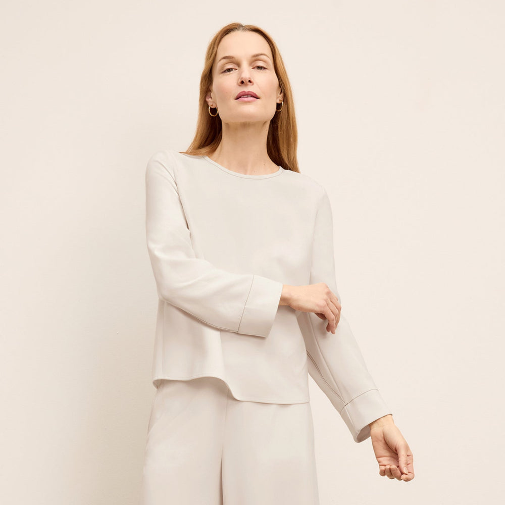 front image of a woman wearing the jules top in eggshell