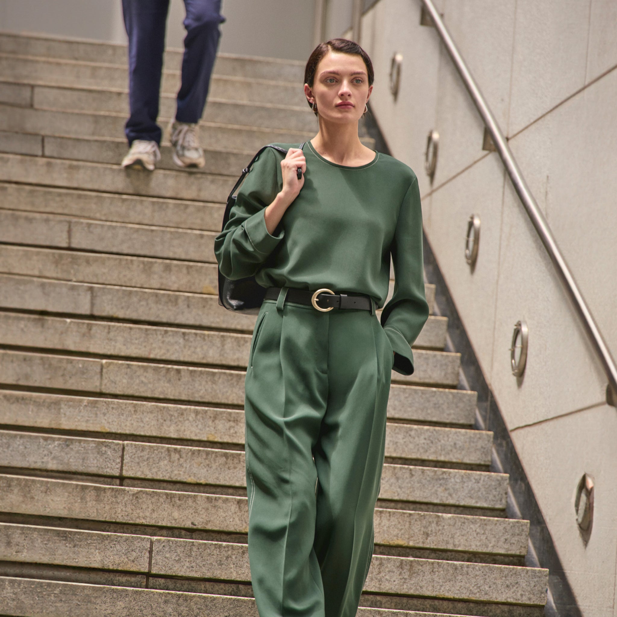 front image of a woman wearing the arlo pants in dusty pine