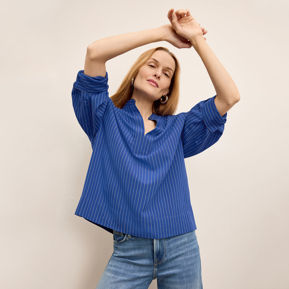 front image of a woman wearing the kylan top in soft stripe