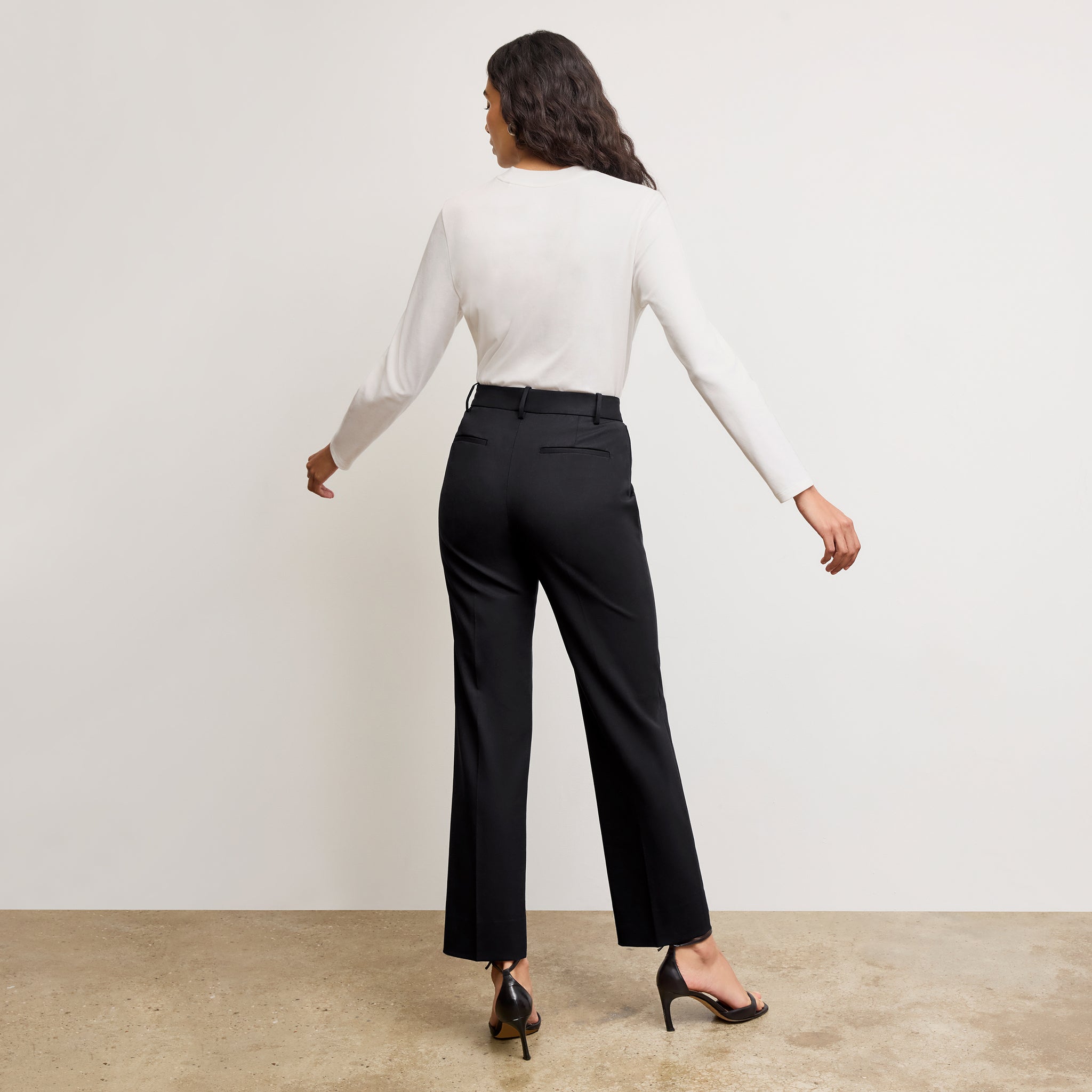 Back image of a woman standing wearing the Raquel T-Shirt in White