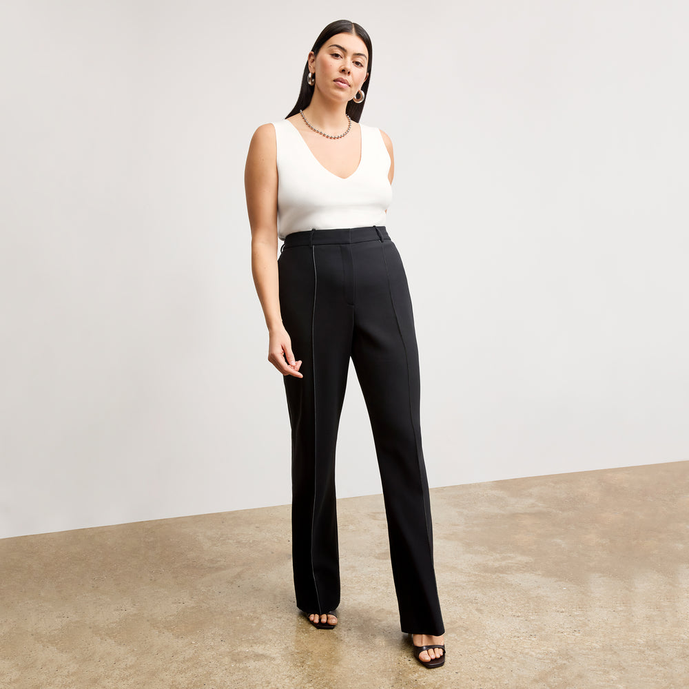 front image of a woman wearing the alecia top in ivory