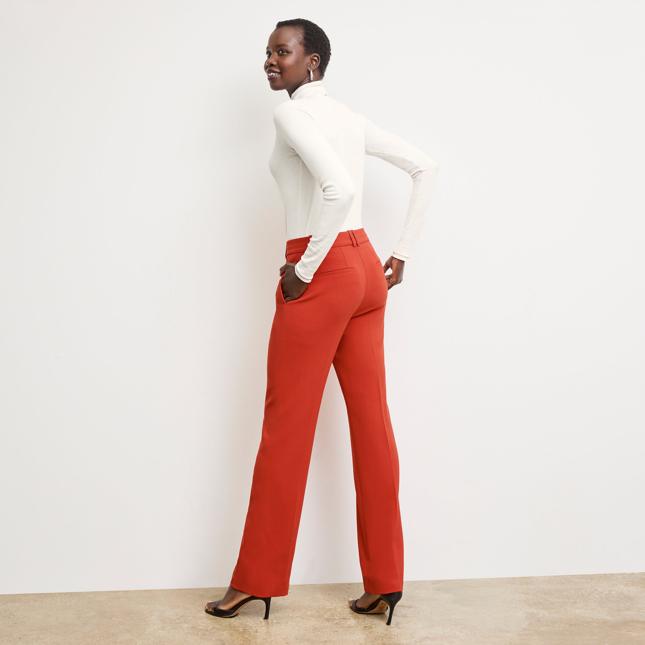 back image of a woman wearing the axam top in white