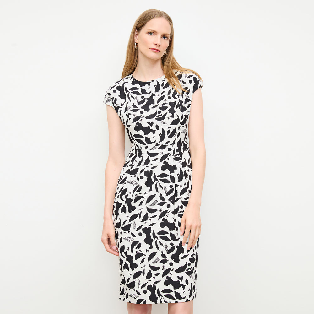 front image of a woman wearing the masha dress in icon print