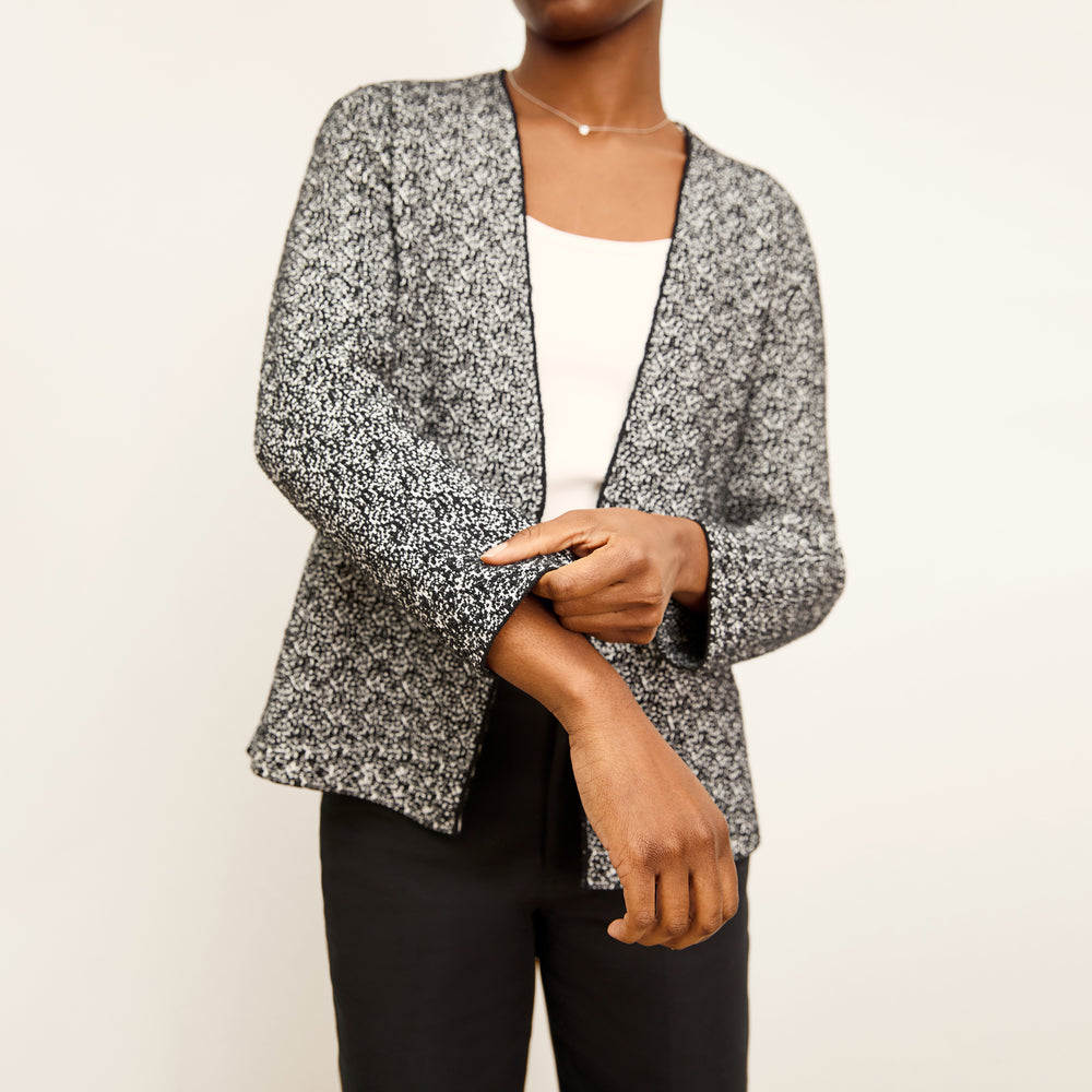 front image of a woman wearing the woolf jardigan in black/ivory