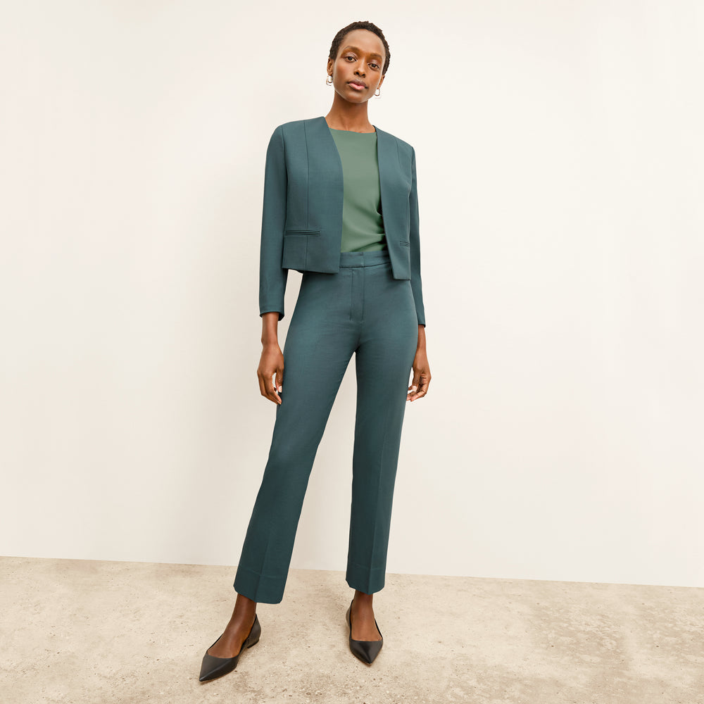 front image of a woman wearing the neale jacket in blue jade