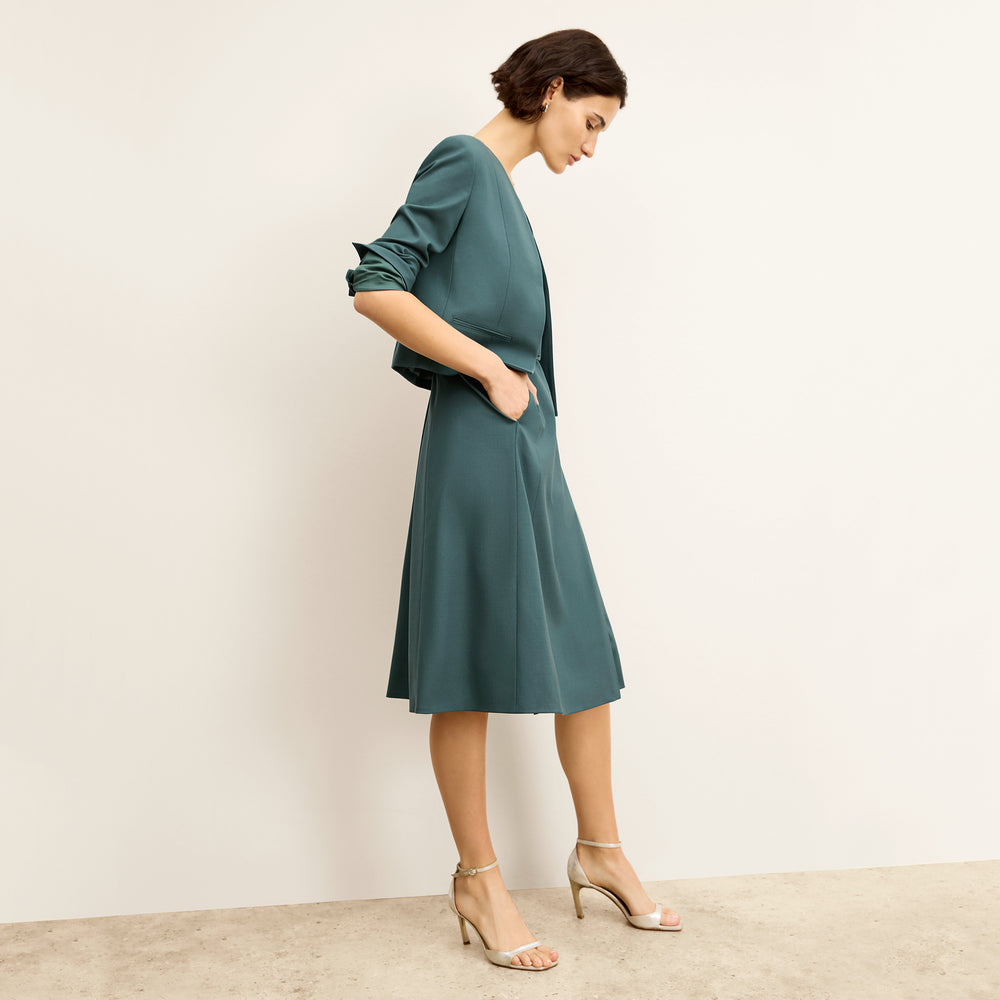 side image of a woman wearing the neale jacket in blue jade