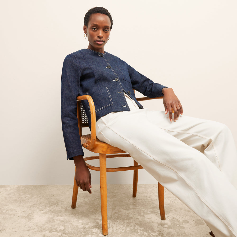 front image of a woman wearing the kane jacket in dark wash