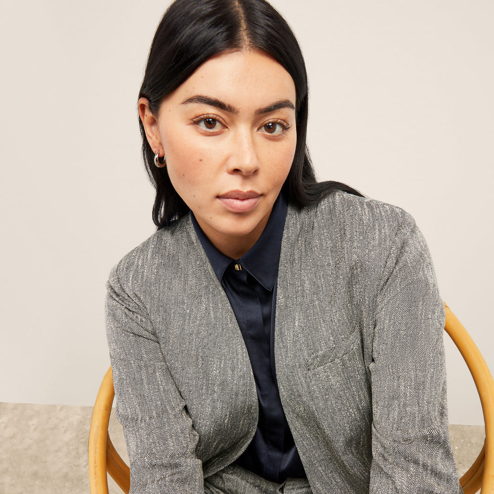 front image of a woman wearing the janette jacket in black/ivory