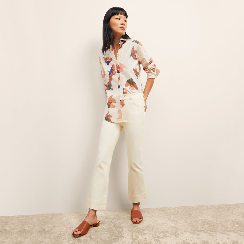 front image of a woman wearing the mila top in hummingbird print