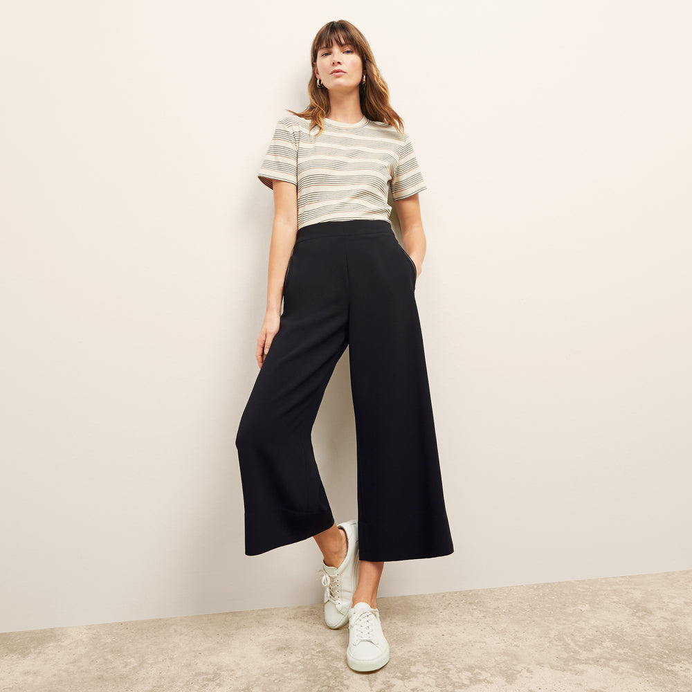 front image of a woman wearing the leslie t-shirt in signature stripe