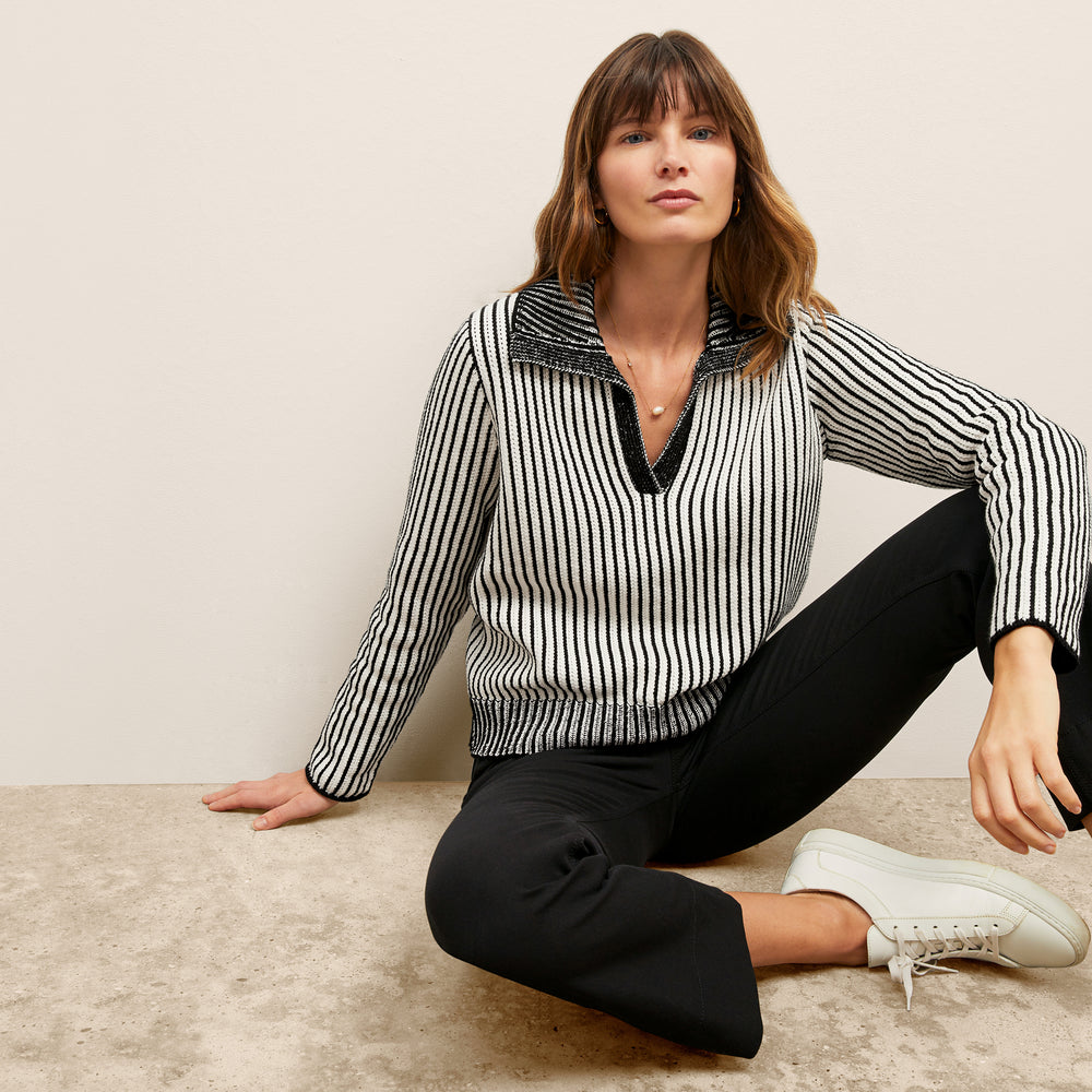 front image of a woman wearing the maja sweater in black/ivory