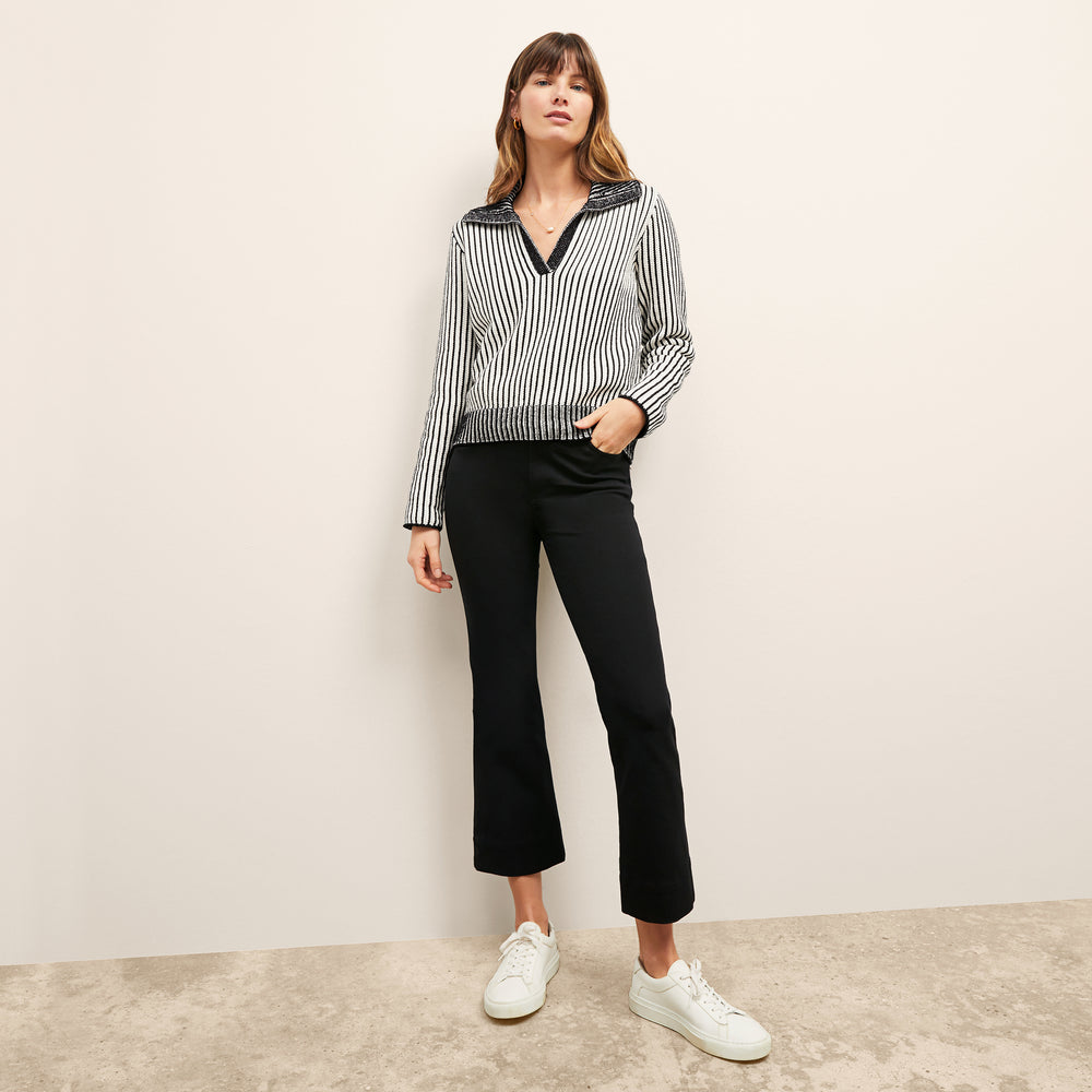 front image of a woman wearing the maja sweater in black/ivory