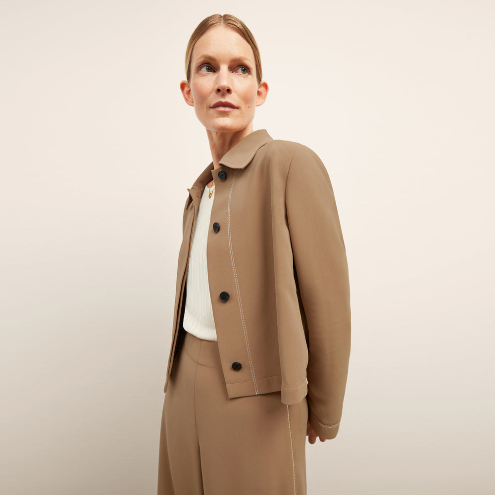 front image of a woman wearing the nicky jacket in saddle
