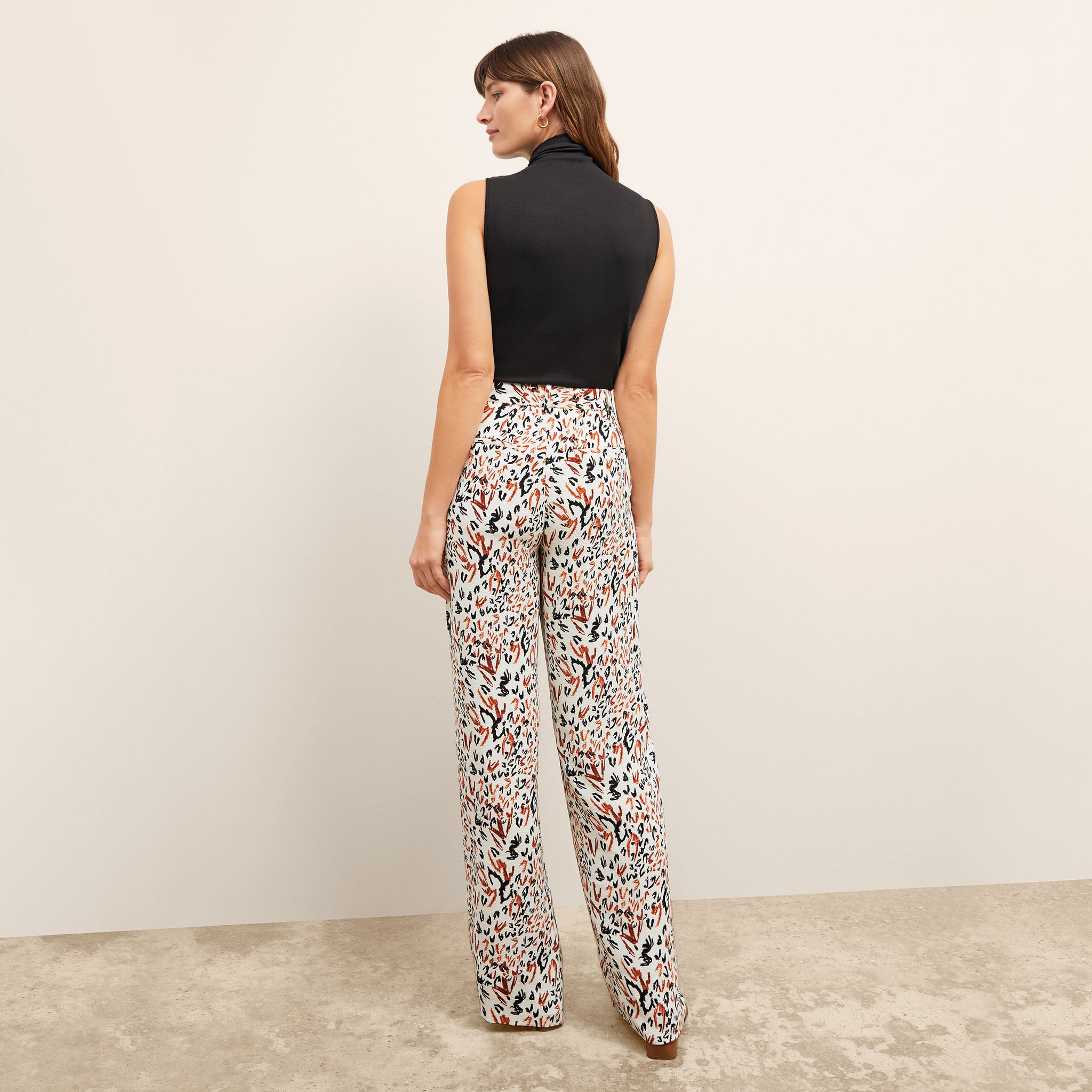 back image of a woman wearing the tinsley trousers in leopard sketch