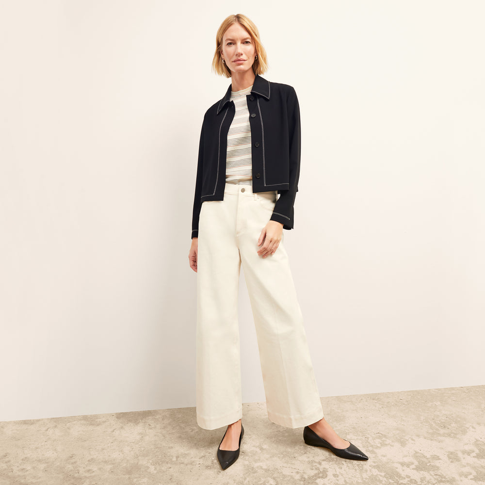 front image of a woman wearing the nicky jacket in black