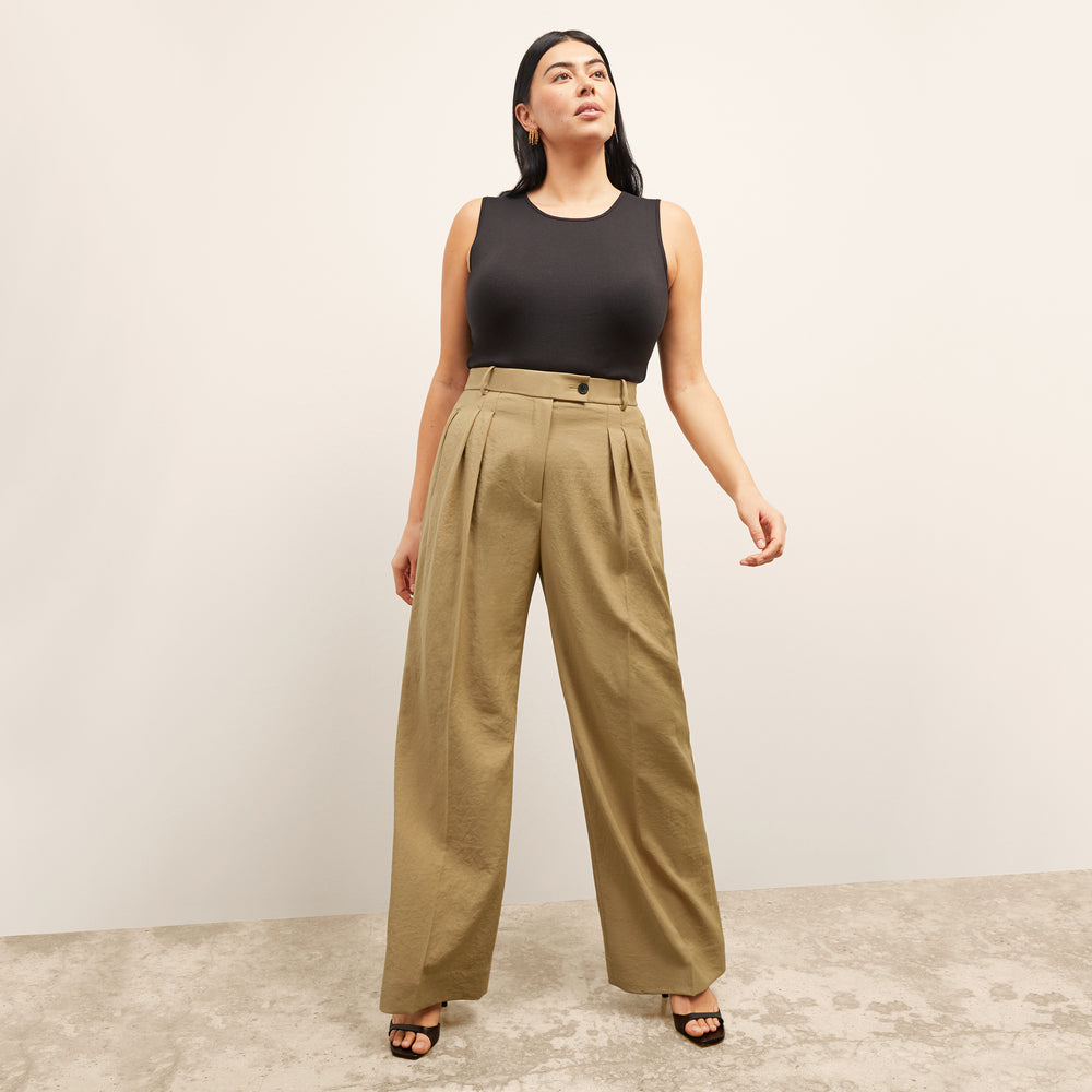 Front image of a woman standing wearing the paige top in fine ribbed cotton in black