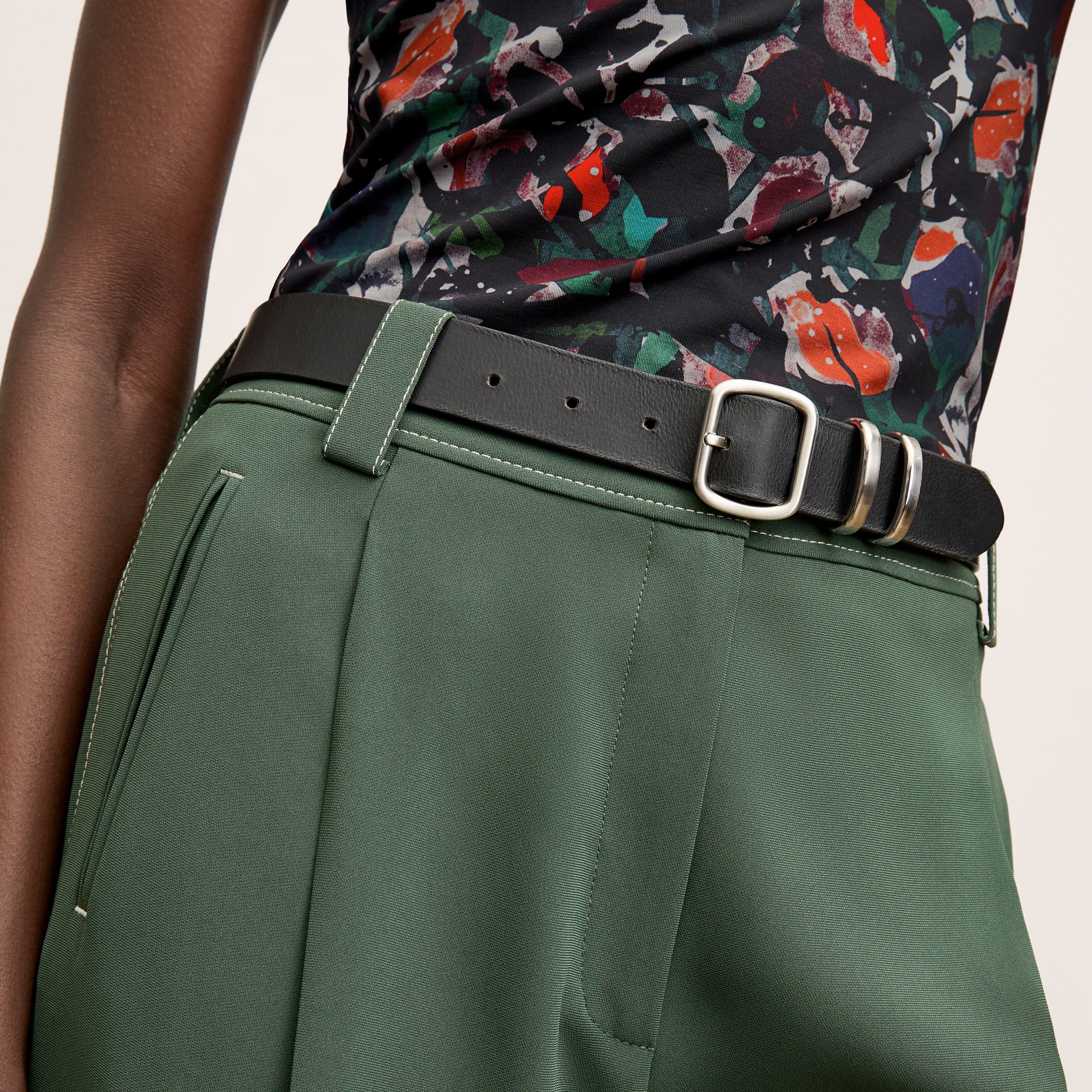 front image of a woman wearing the arlo pants in dusty pine