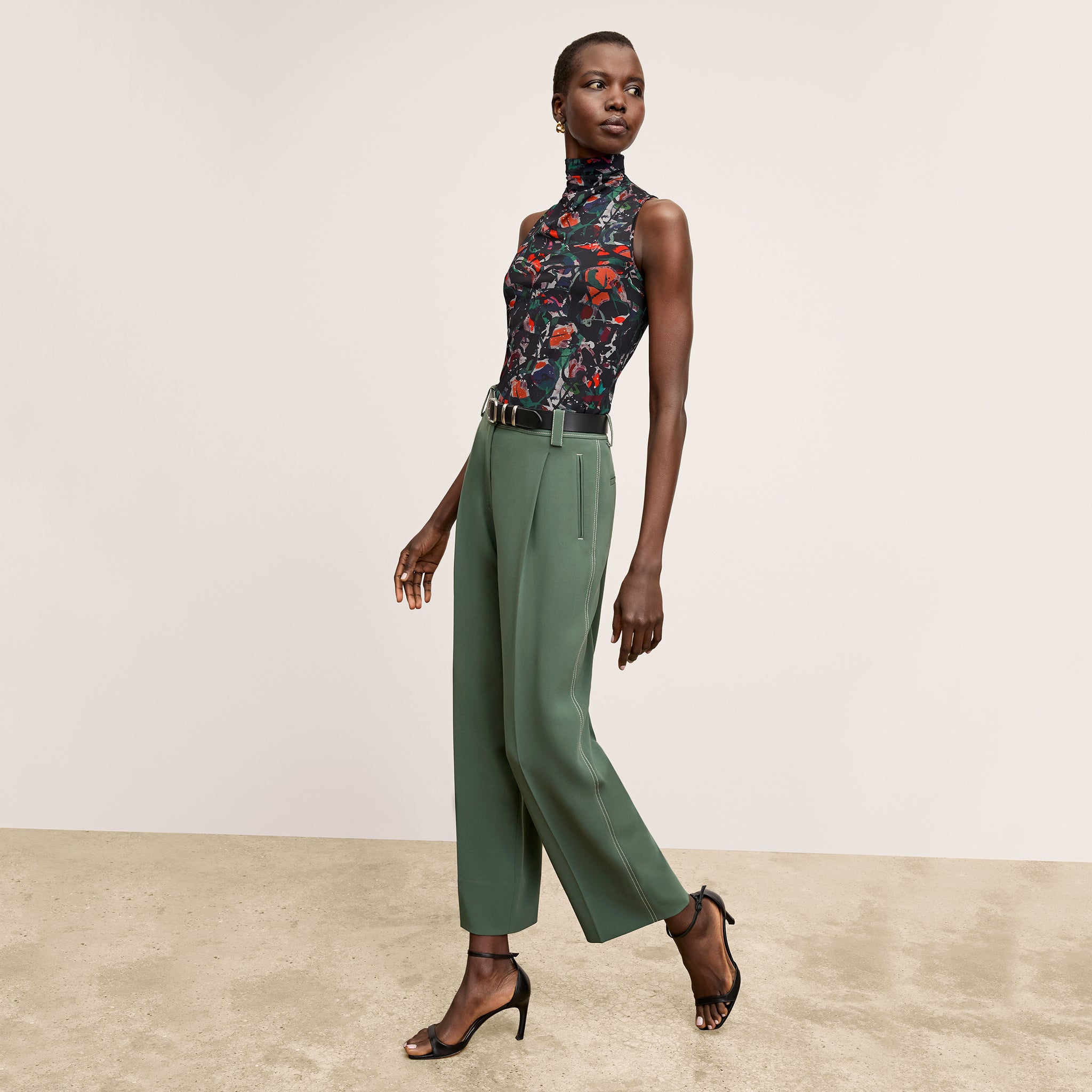 front image of a woman wearing the arlo pants in dusty pine 