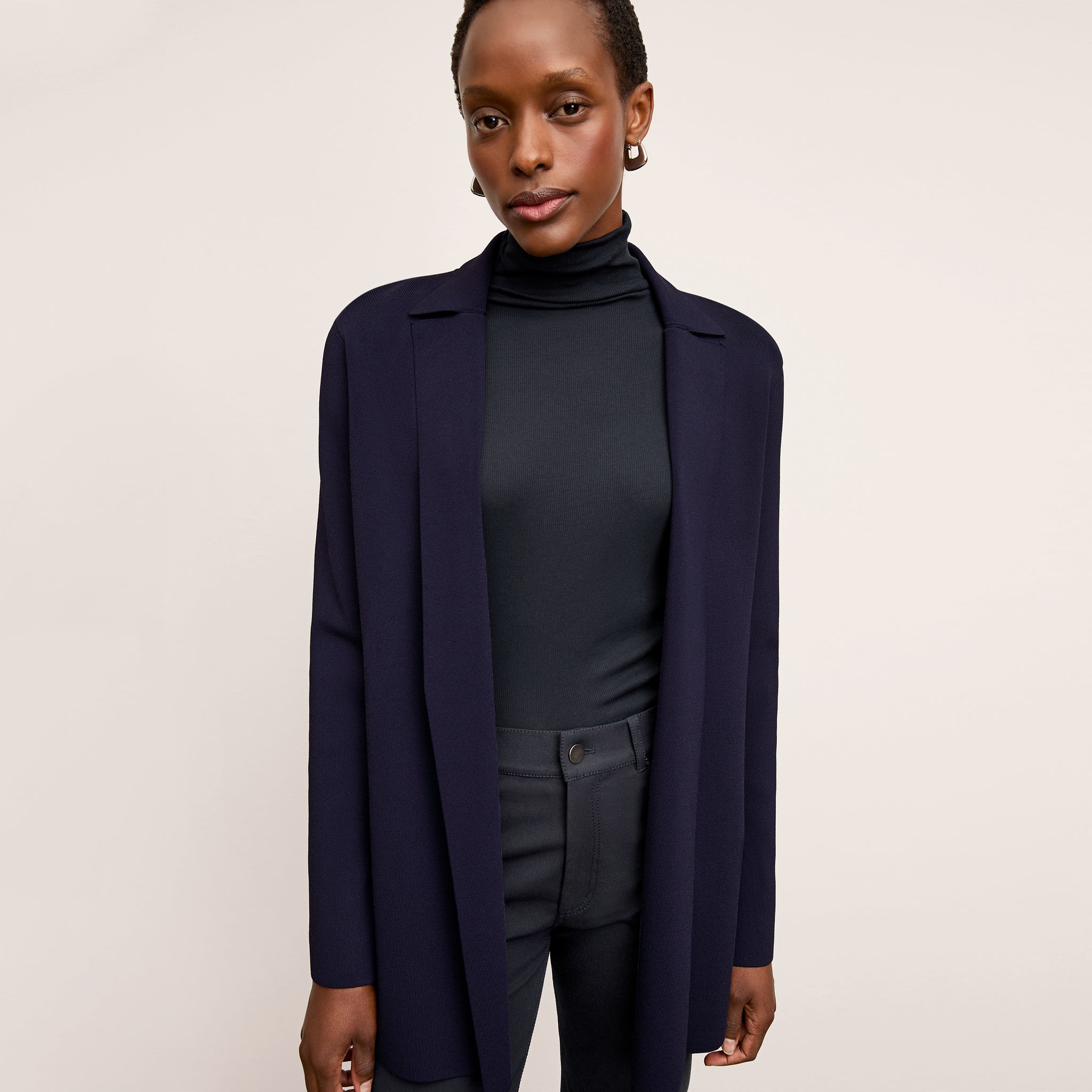 Front image of a woman wearing the axam top in dark navy
