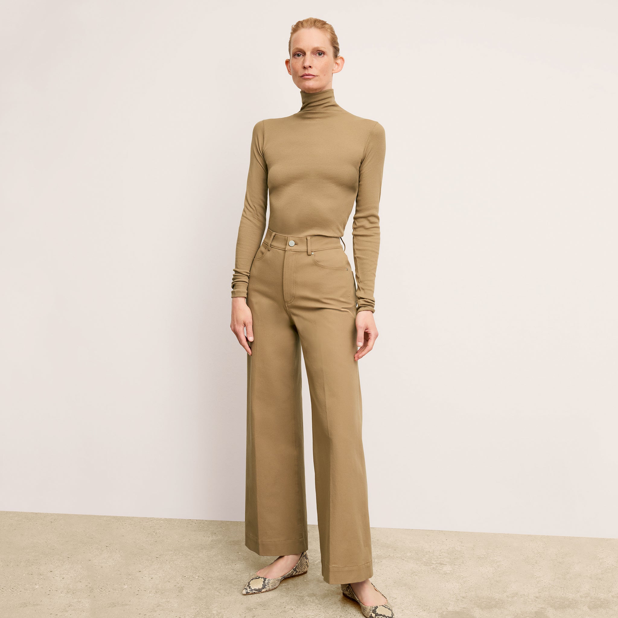 front image of a woman wearing the axam in saddle 