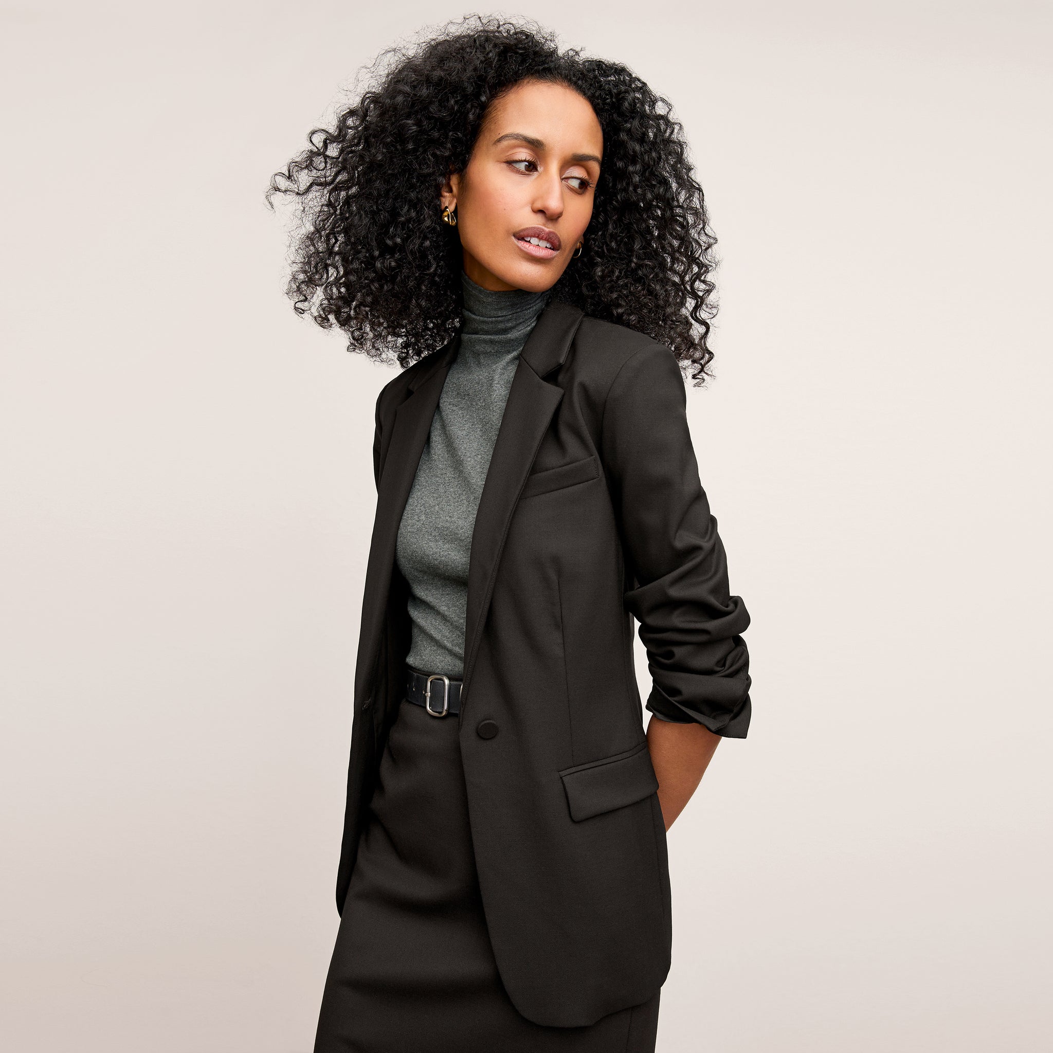 Front image of a woman standing wearing the Yiyan Blazer in Black 