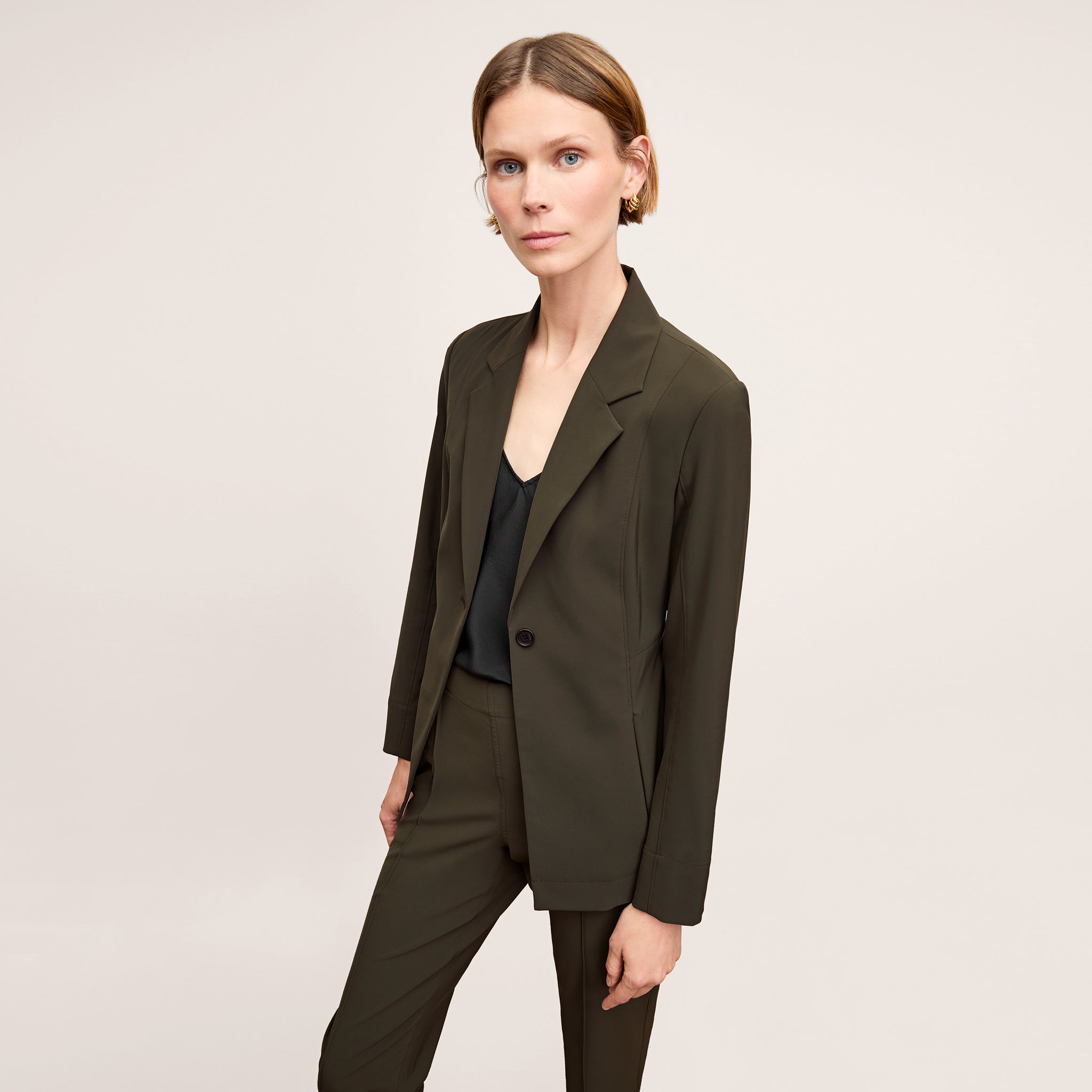 Front image of a woman standing wearing the Moreland jacket in olive 