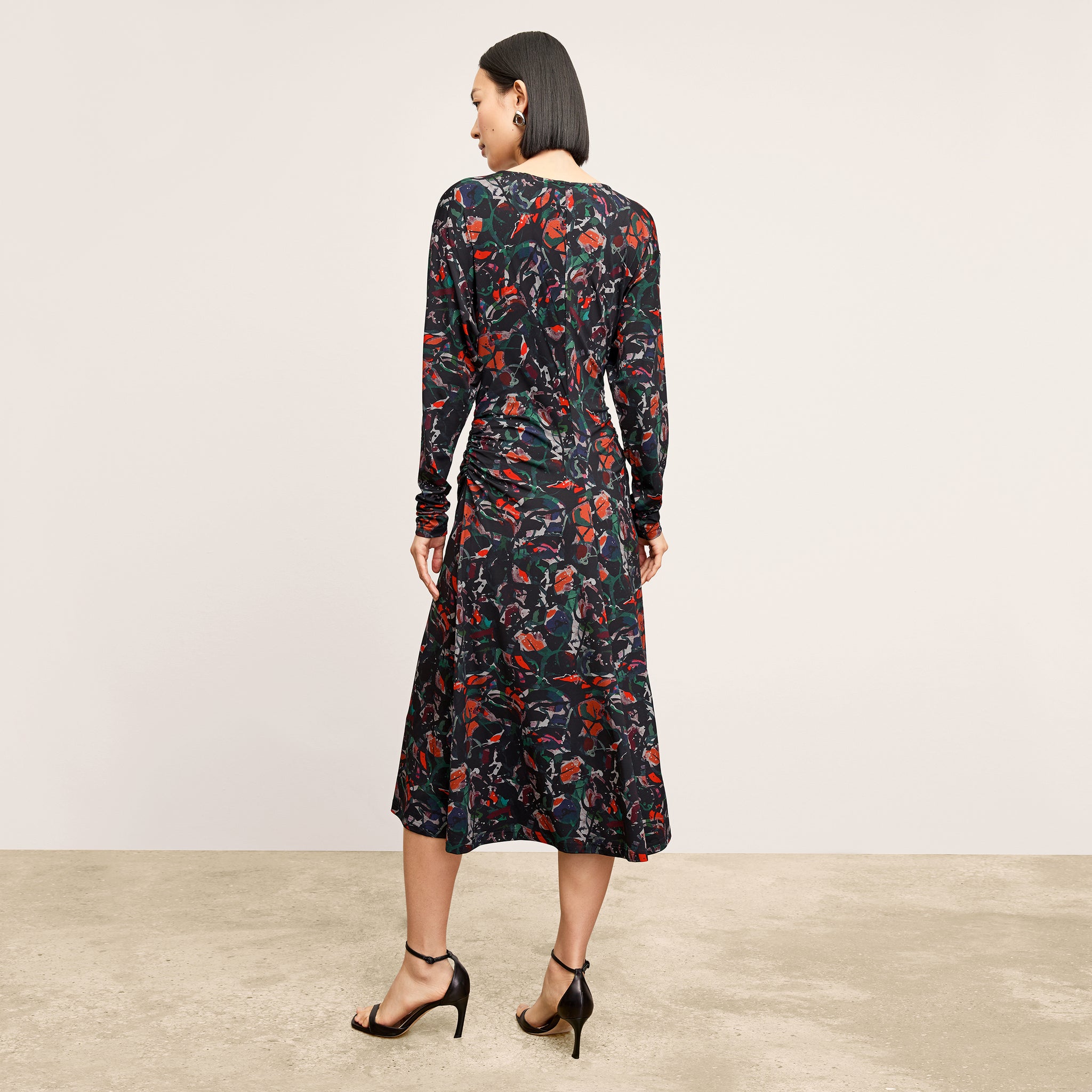 back image of a woman wearing the johnna dress in splatter pop
