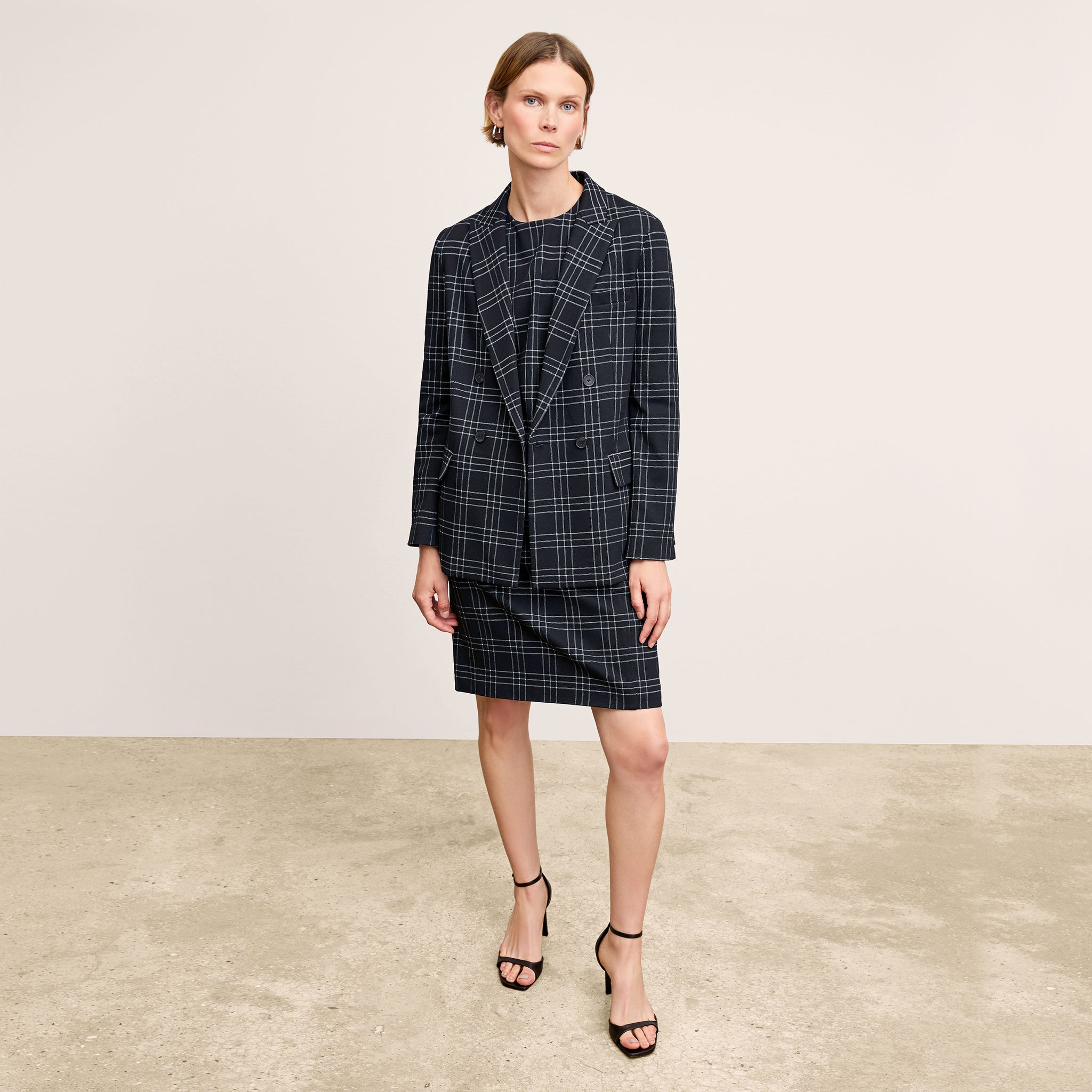 front image of a woman wearing the lancia dress in black/white