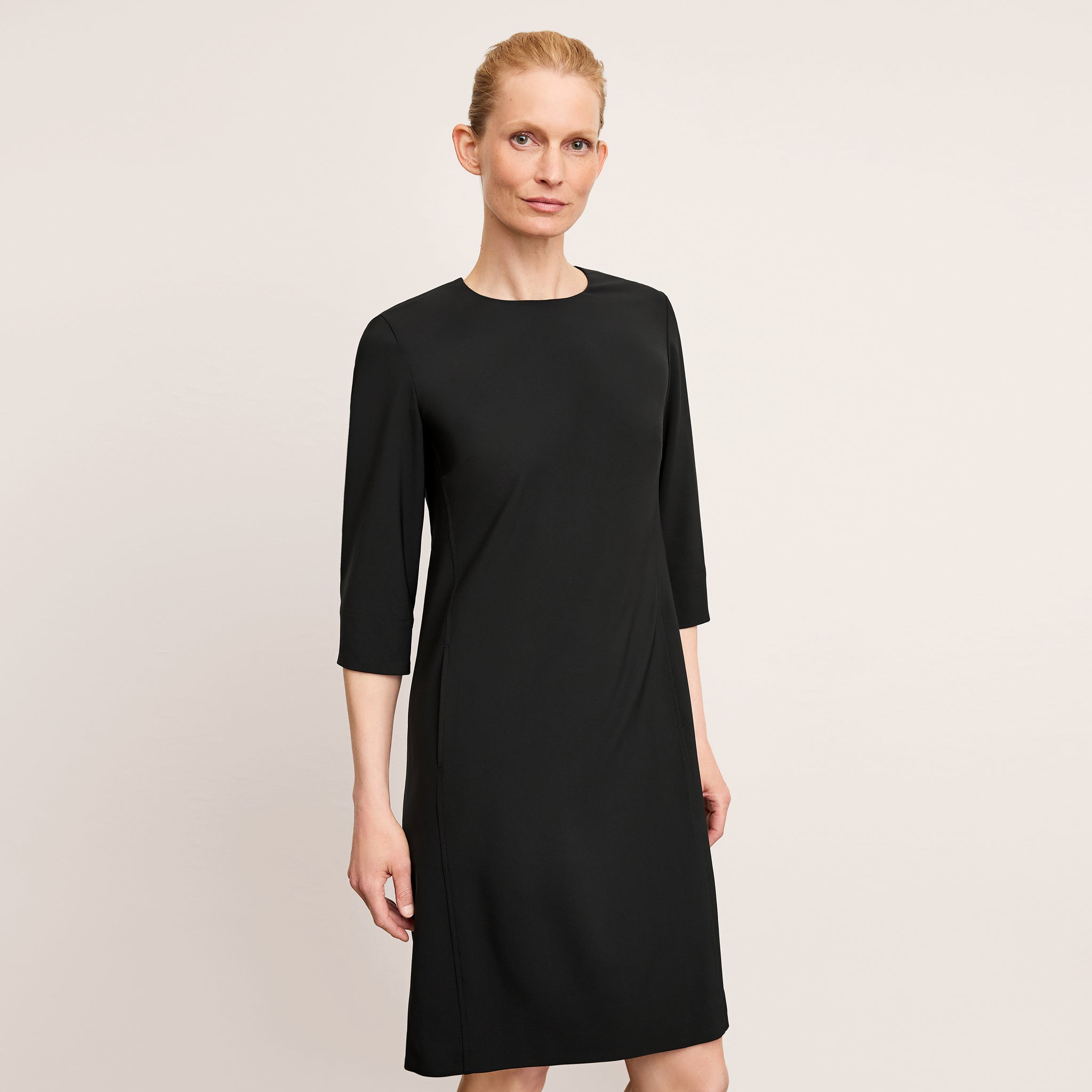 front image of a woman wearing the lancia dress in black 