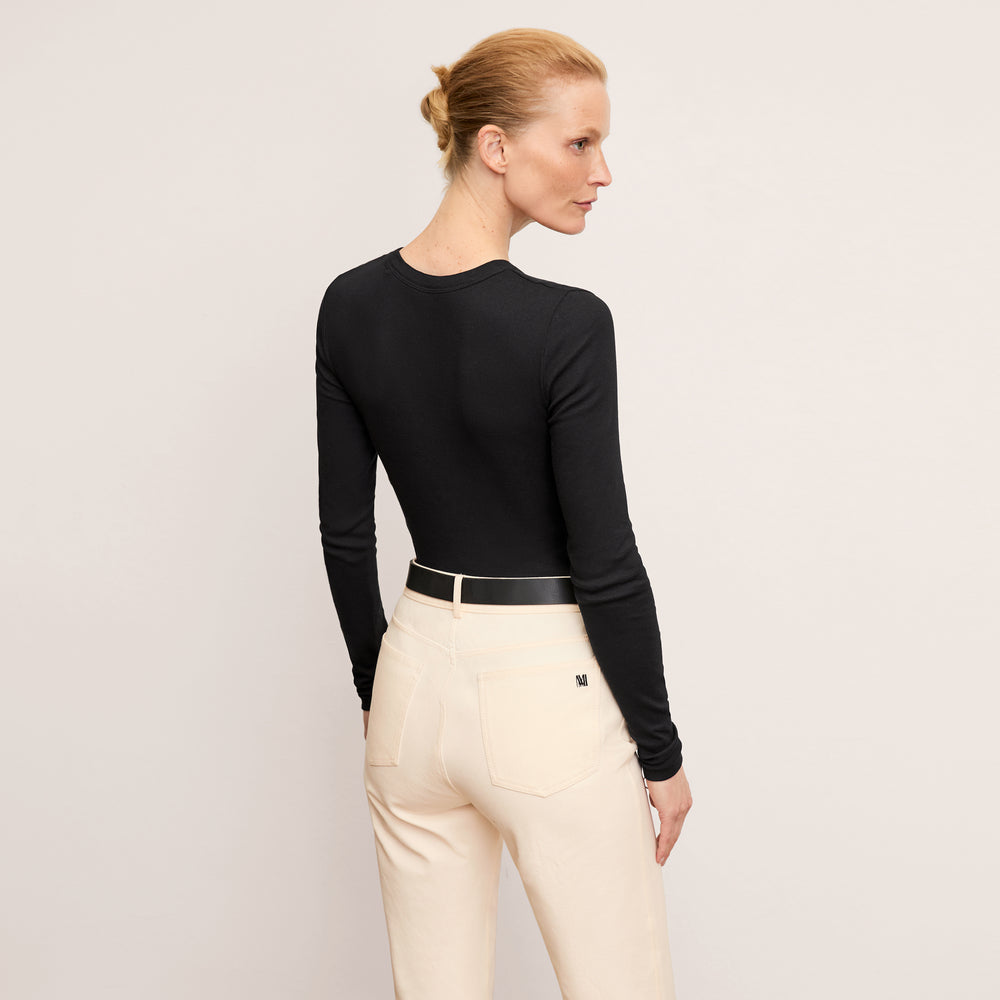back image of a woman wearing the malley t-shirt in black