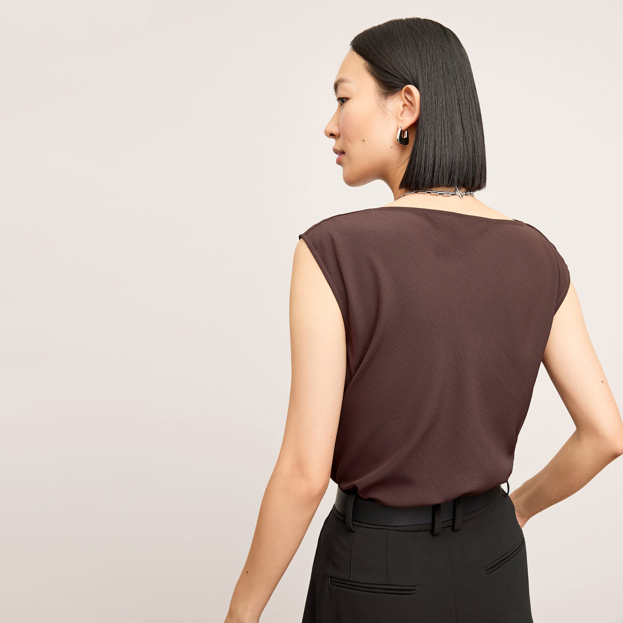 back image of a woman wearing the nora top in espresso