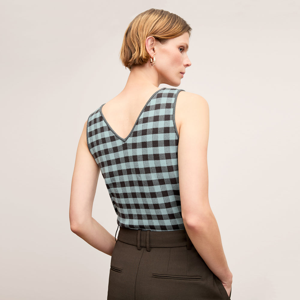 back image of a woman wearing the peggy top in picnic check