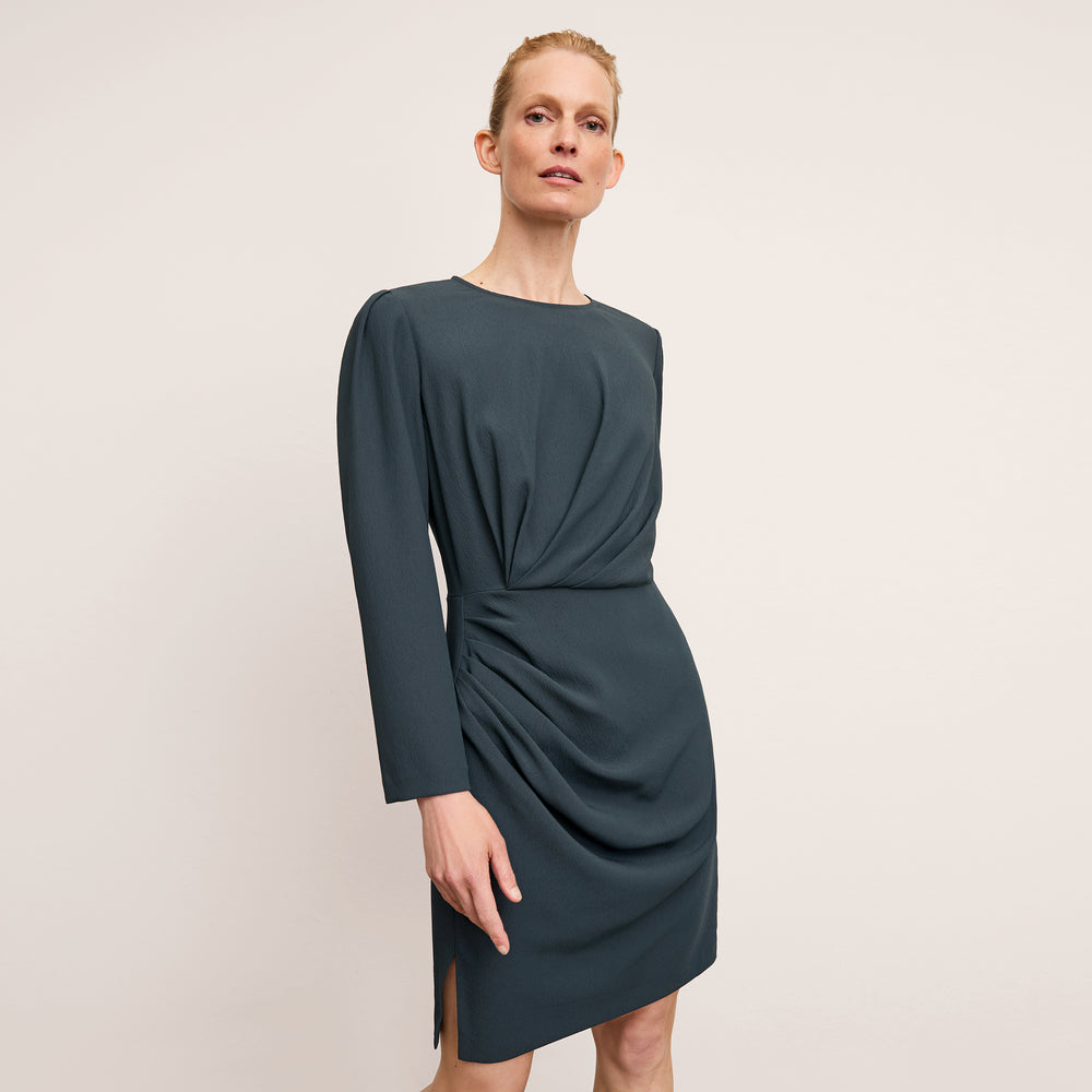 front image of a woman wearing the wallen dress in ocean
