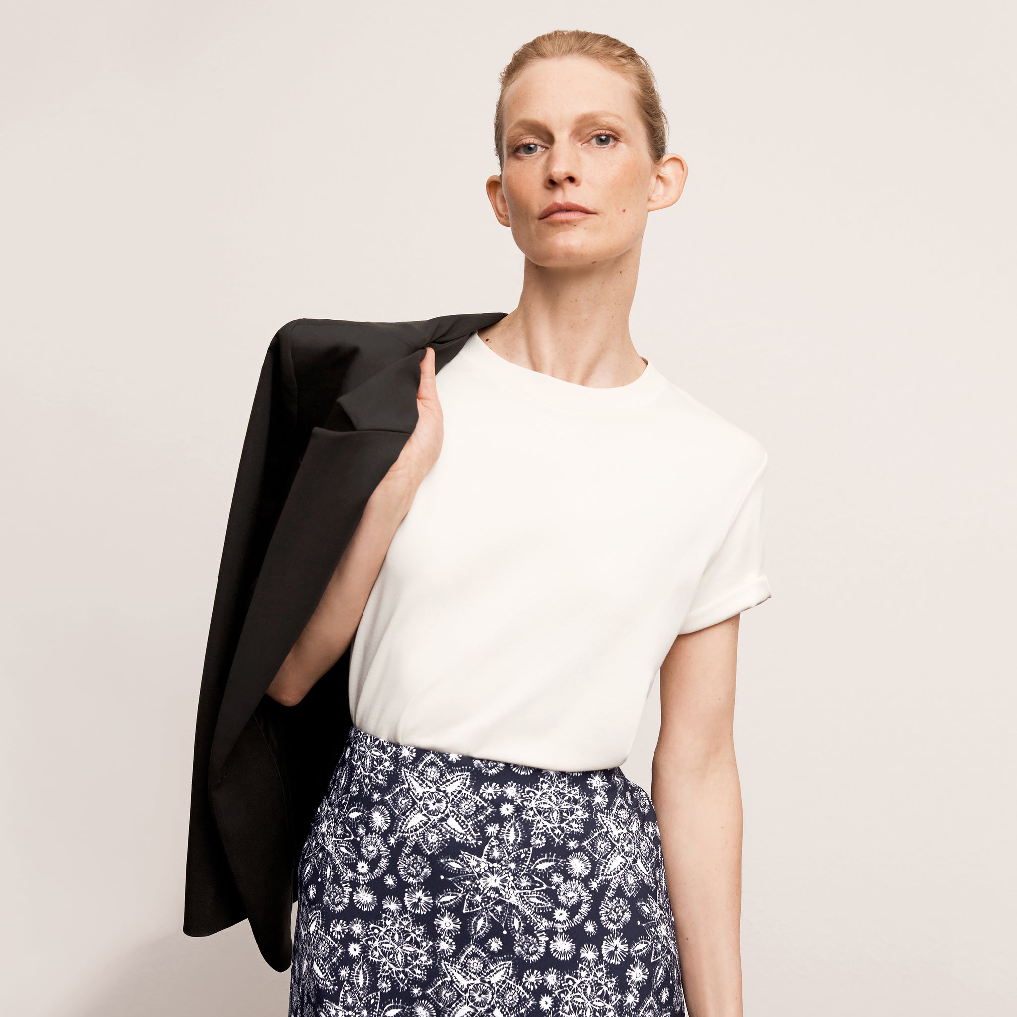 Front image of a woman wearing the leslie top in compact cotton in ivory
