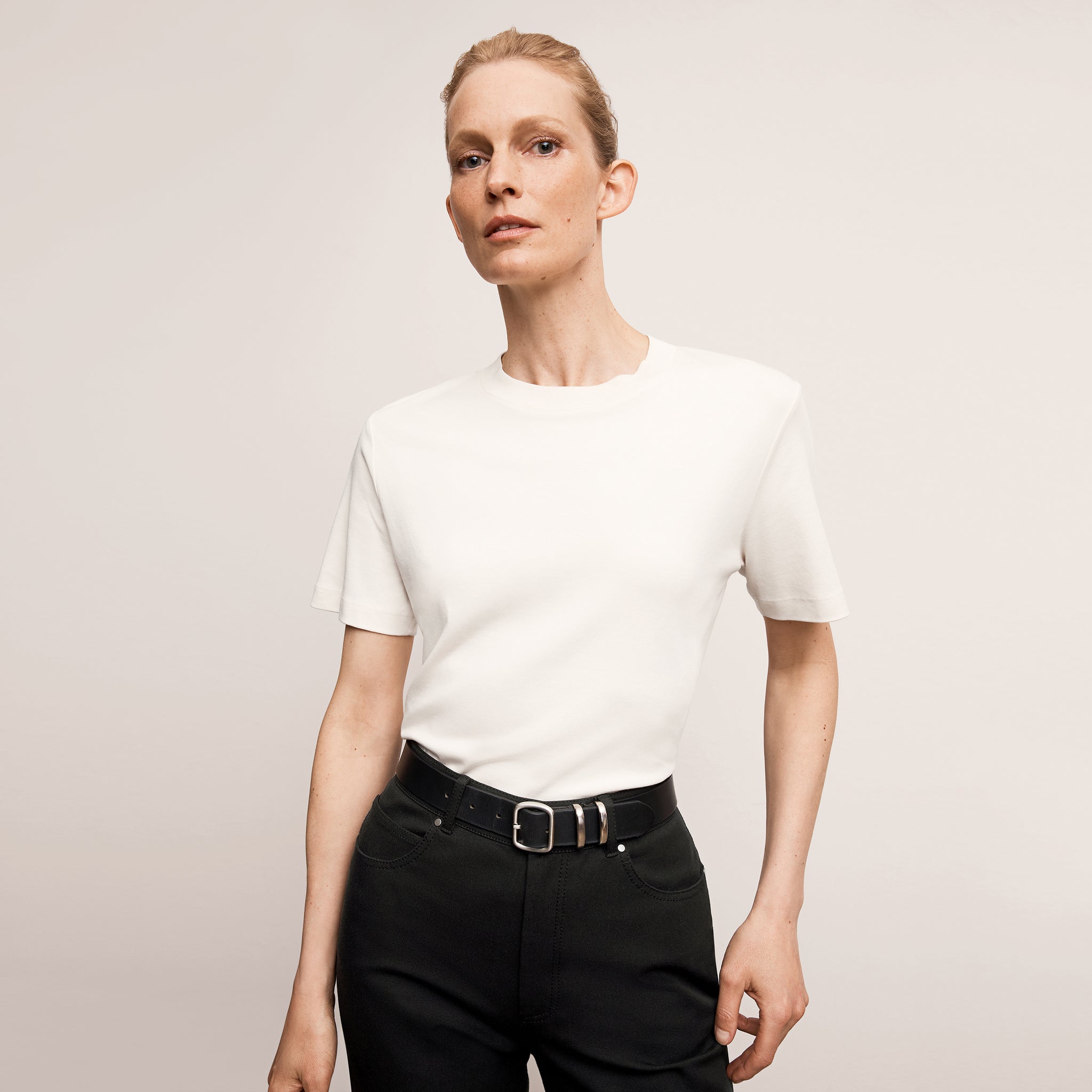 Front image of a woman wearing the leslie top in compact cotton in ivory 
