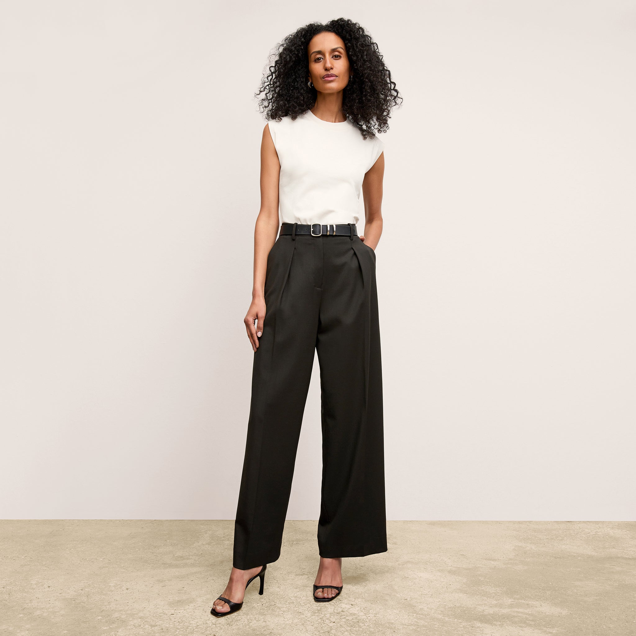 front image of a woman wearing the zuri pant in black
