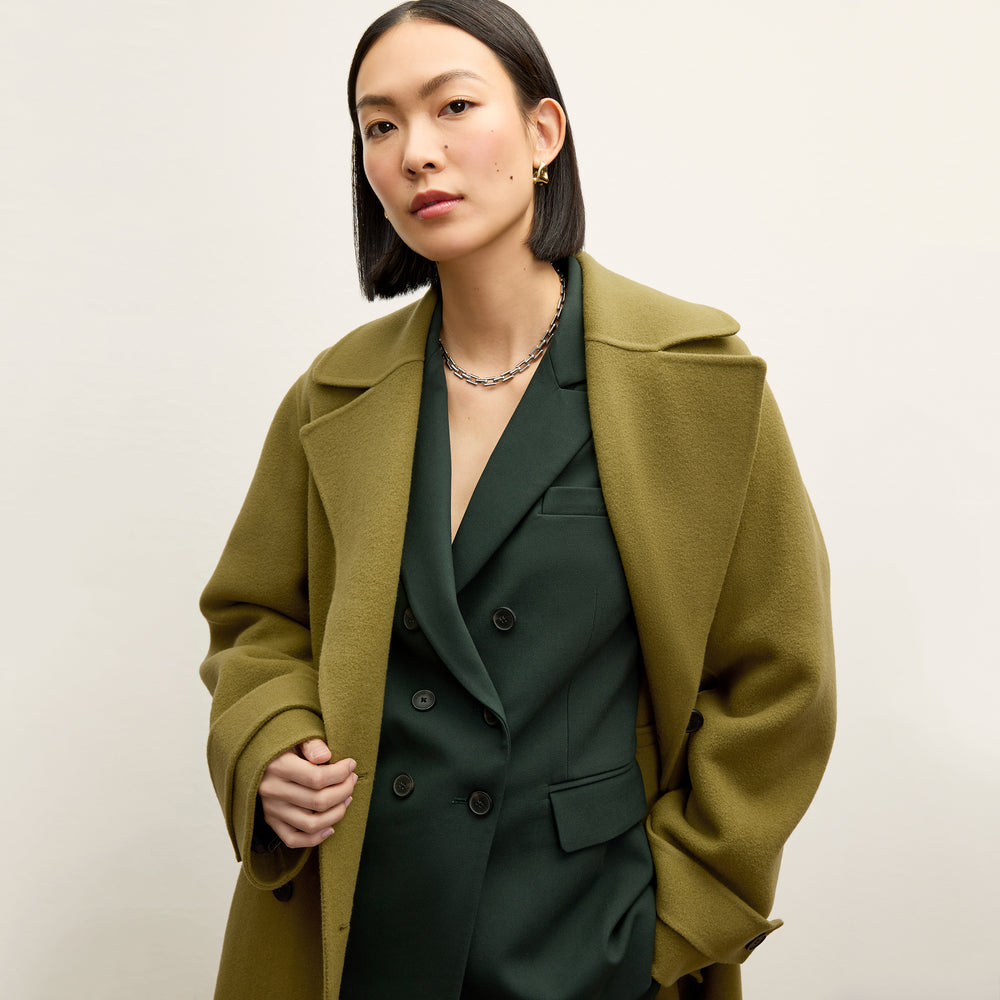 front image of a woman wearing the kati jacket in dark emerald