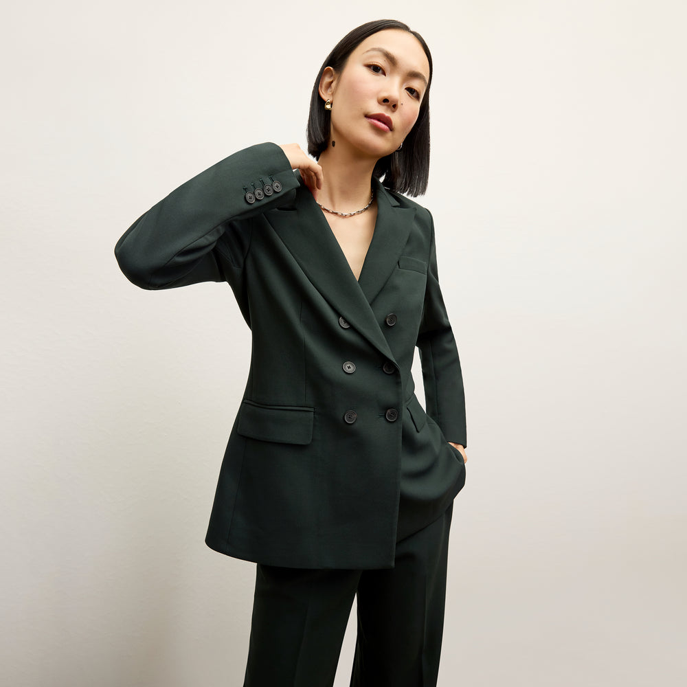 front image of a woman wearing the kati jacket in dark emerald