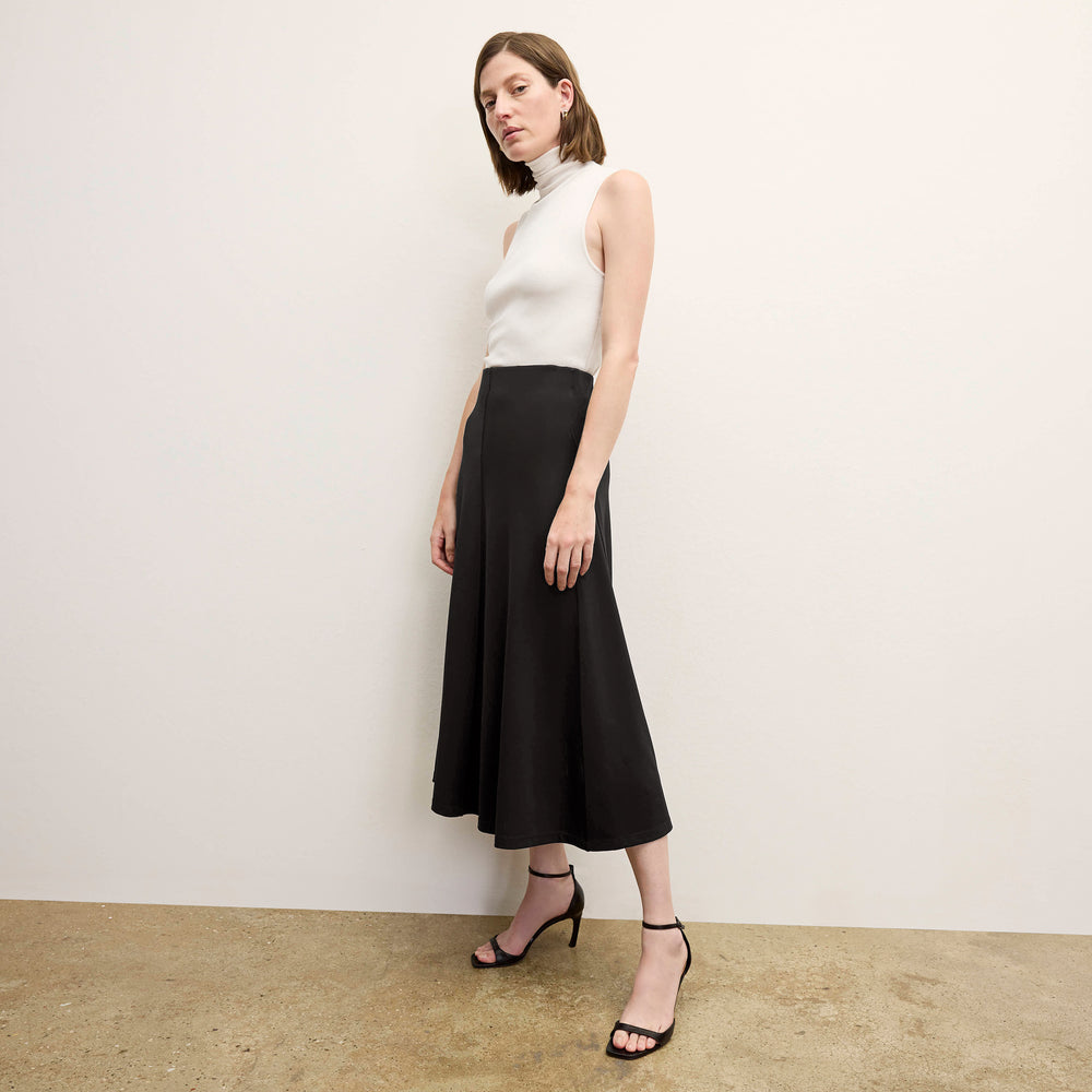 front image of a woman wearing the misty skirt in black