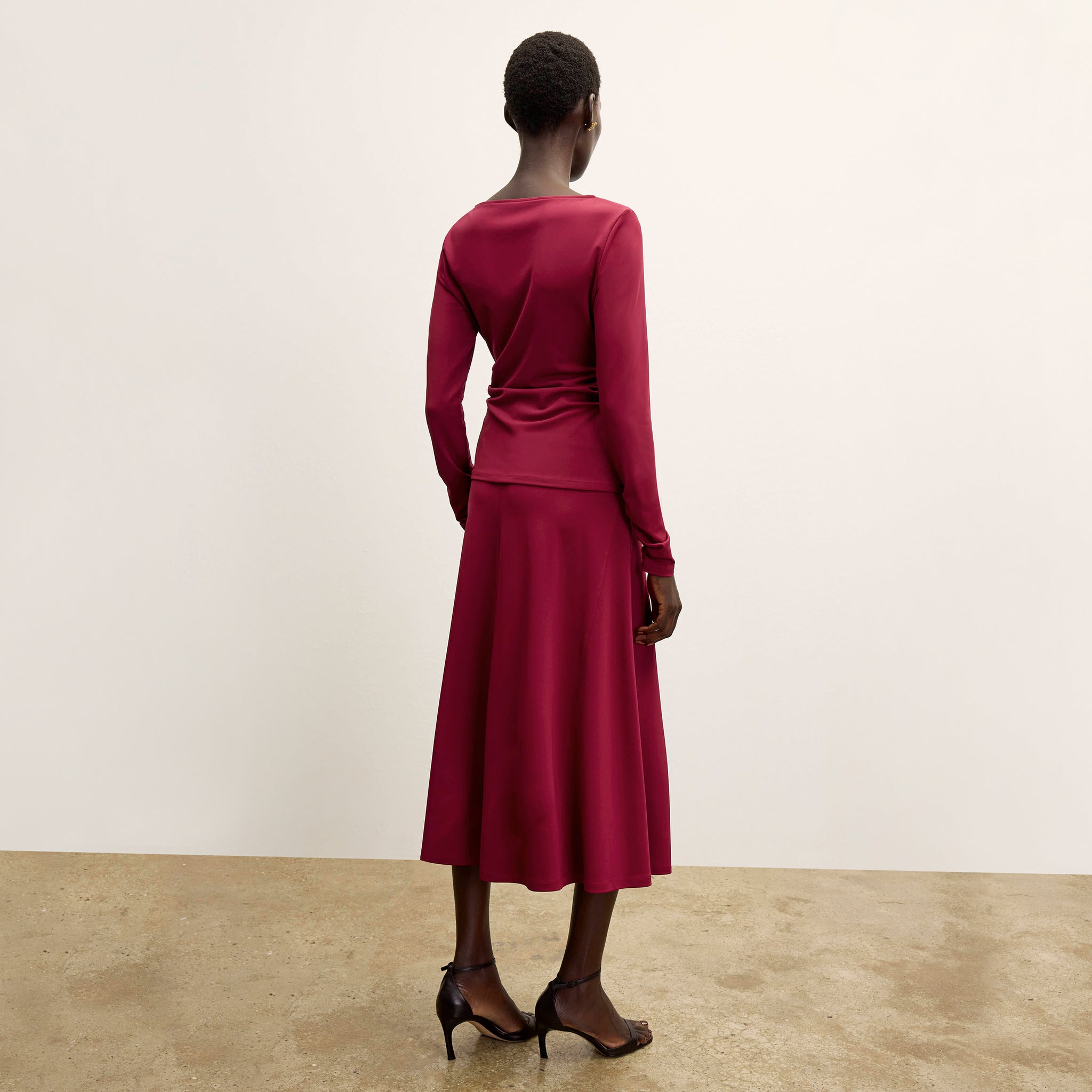 back image of a woman wearing the percy top in grenache