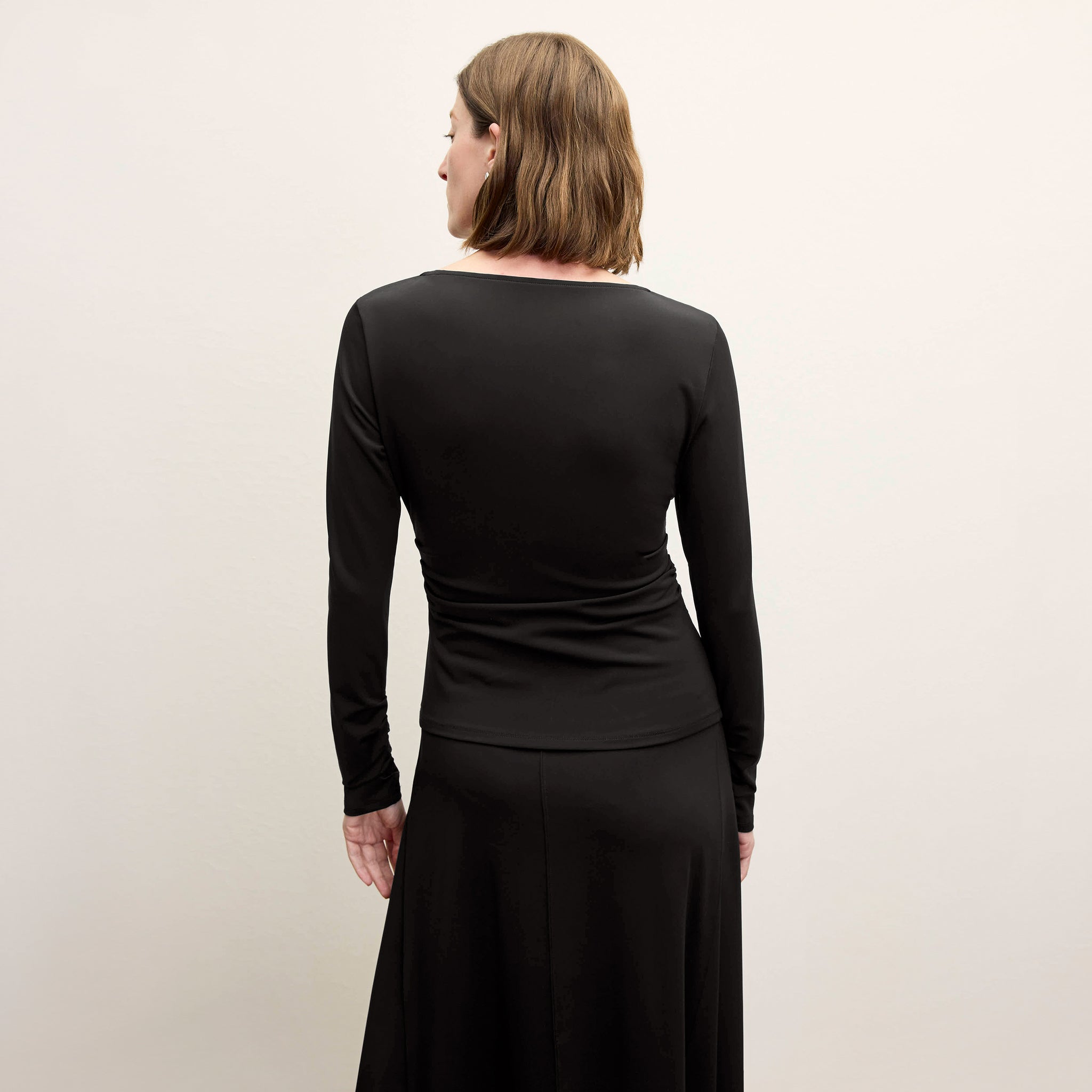 back image of a woman wearing the percy top in black