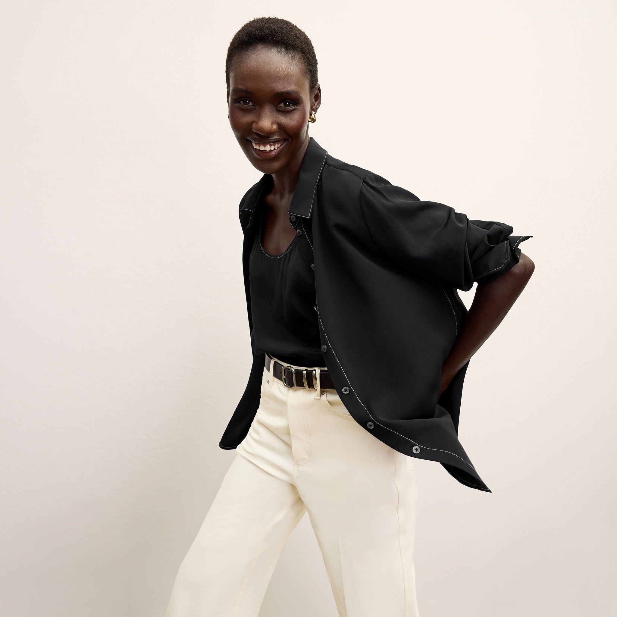 front image of a woman wearing the mira top in black