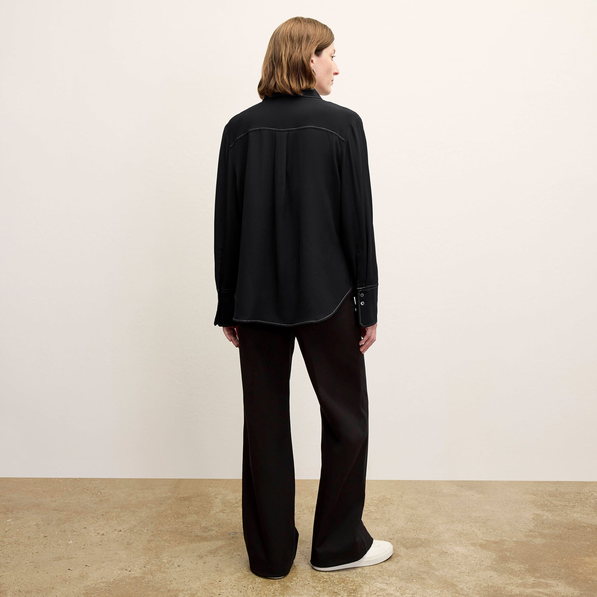 back image of a woman wearing the mira top in black