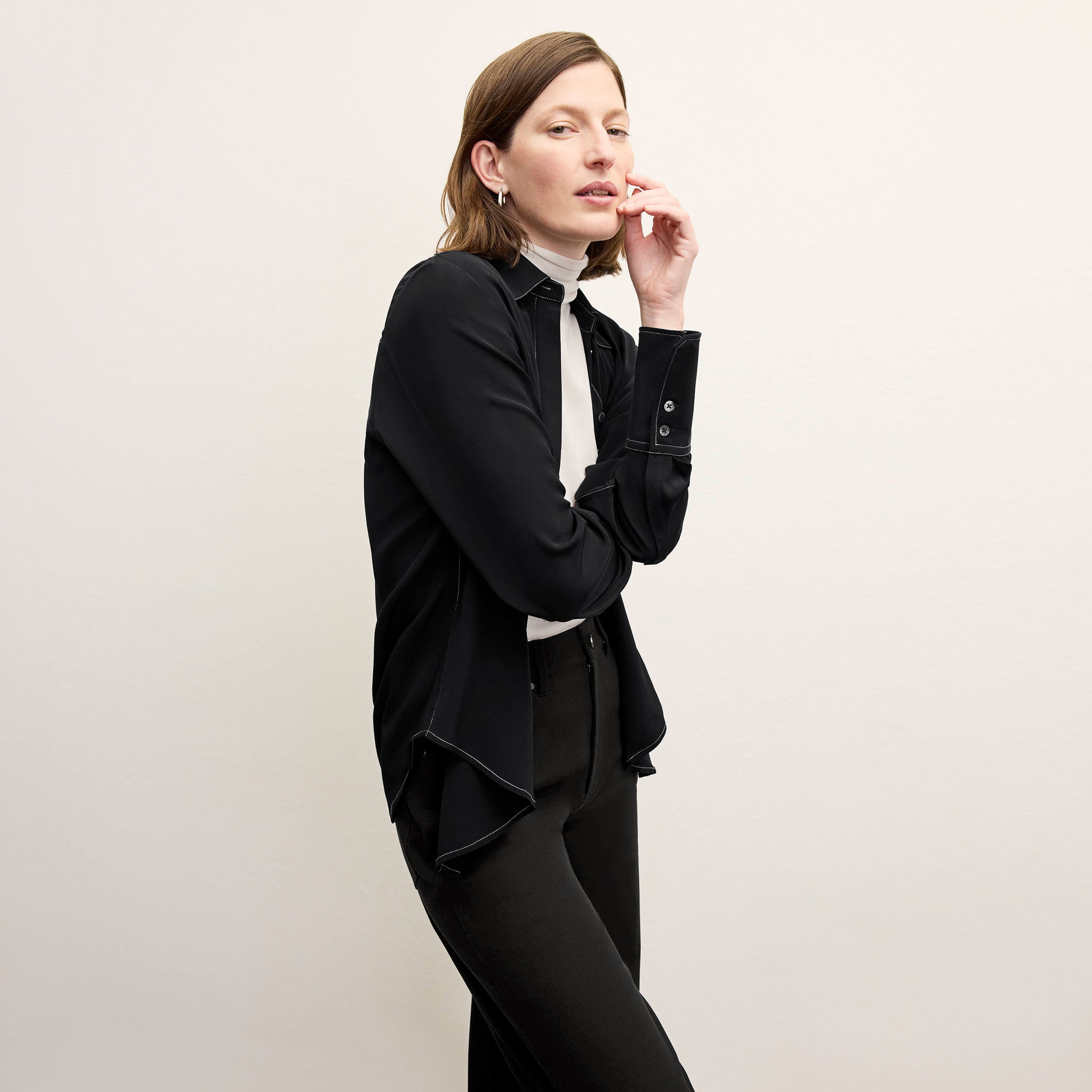 front image of a woman wearing the mira top in black